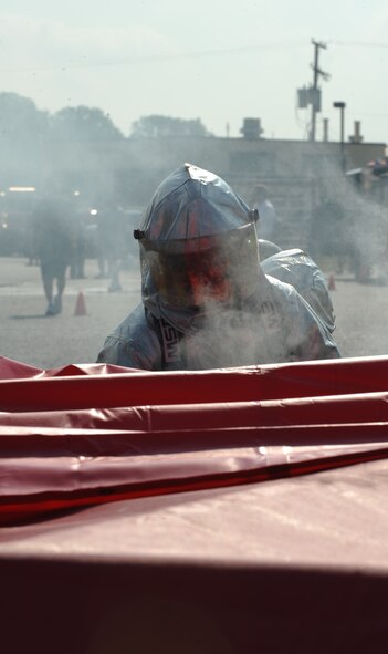 Airmen from the 2nd Force Support Squadron prepare to enter a confined space filled with smoke for the search and rescue event during the third annual Fire Muster on Barksdale Air Force Base, La., June 10. Participants must crawl through a smoked-filled area and retrieve a 175-pound mannequin. This event simulates disorientation while searching for victims in a smoke-filled home or warehouse. (U.S. Air Force photo/Airman 1st Class Micaiah Anthony)(RELEASED)