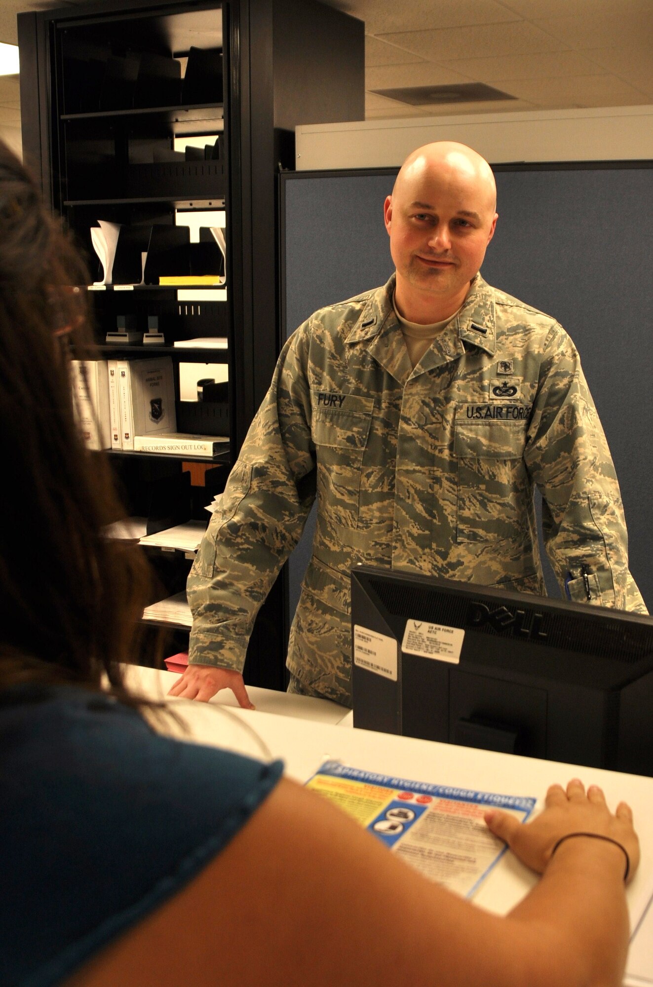 1st Lt. Jay Fury, 14th Medical Group practice manager, converses with a member of his staff on June 8. (U.S. Air Force photo/Airman 1st Class Chase Hedrick)
