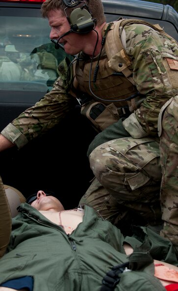 U.S. Air Force Capt. Matthew Bury, 38th Rescue Squadron combat rescue officer, checks the vital signs of a simulated patient during a medical evacuation exercise June 9 at Moody Air Force Base, Ga. The unit members trained on a variety of realistic scenarios during the exercise to prepare for deployment. (U.S. Air Force photo by Airman 1st Class Nicholas Benroth/Released)