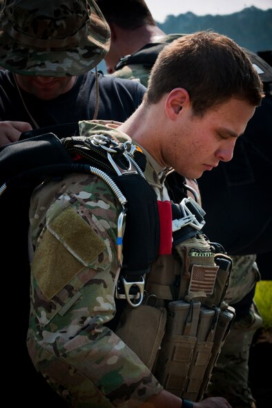 U.S. Air Force Senior Airman Eric Braddock, 38th Rescue Squadron pararescueman, has his equipment checked before boarding an HC-130 Combat King while participating in a medical evacuation training exercise June 9 at Moody Air Force Base, Ga.  Each pararescueman’s equipment was checked by other team members for safety before loading the aircraft. (U.S. Air Force photo by Senior Airman Benjamin Wiseman/Released)