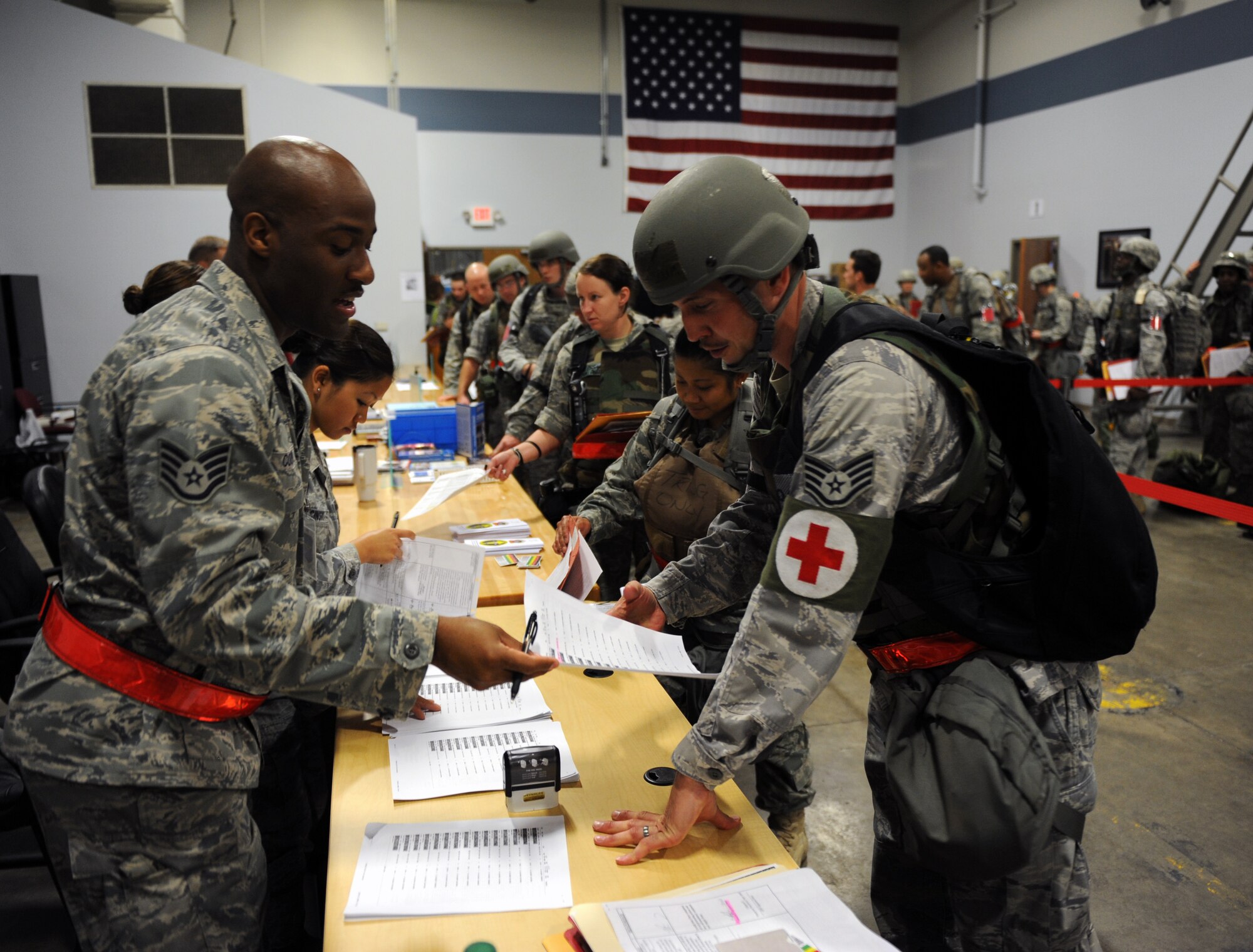 Members of Team Little Rock pass through a processing line during an operational readiness exercise June 4, 2011, at Little Rock Air Force Base, Ark. The processing line, or “quick fire line,” is where members have their paperwork reviewed before departing the base. (U.S. Air Force photo by Airman 1st Class Rusty Frank)