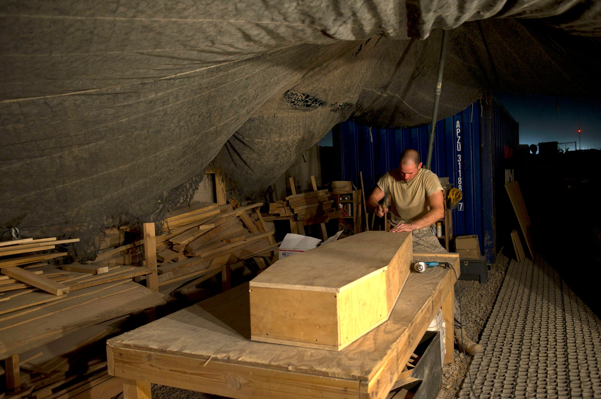 Master Sgt. Jason Reininger builds a child-size coffin to be turned over to the hospital at Camp Bastion, Afghanistan. Sergeant Reininger is an aerospace medical technician assigned to the 451st Expeditionary Aeromedical Evacuation Squadron. (U.S. Air Force photo/Master Sgt. Adrian Cadiz)