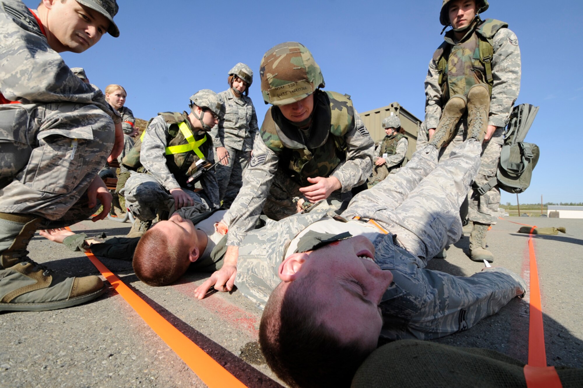 Air Force Staff Sgt. Scott Lauitzen, 3rd Equipment Maintenance Squadron, checks on moulaged role players following a simulated incident during Polar Force 11-5. (U.S. Air Force photo/Steve White)