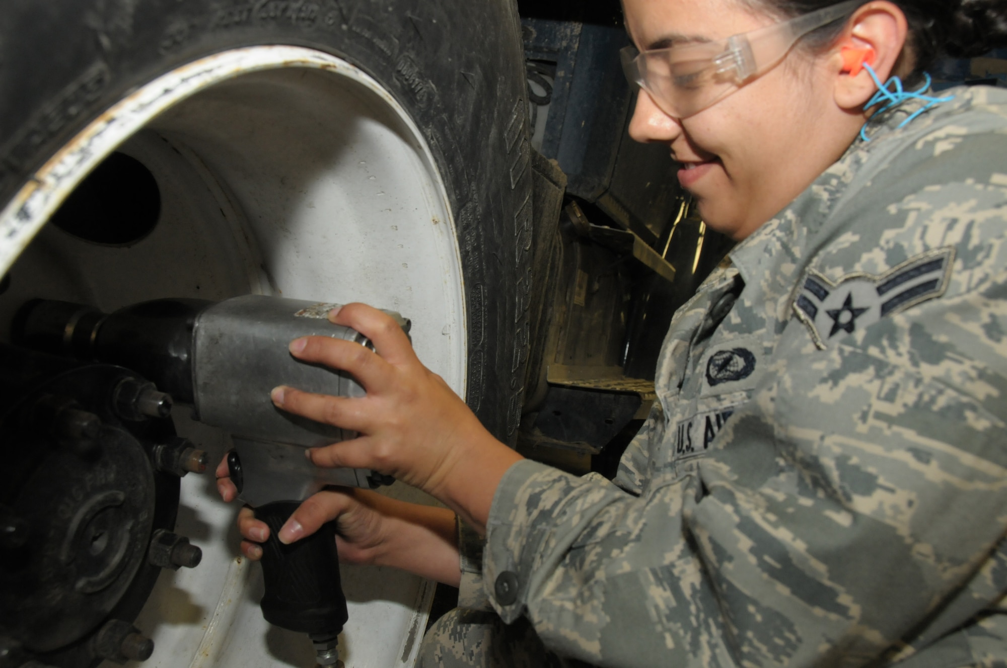 Airman First Class Ashley Ramirez, a journalist with the 146th Airlift Wing Public Affairs, Channel Islands Air National Guard Station, Calif. tries her hand at removing lug nuts from a five-ton vehicle during an annual training deployment at Joint Base Elmendorf-Richardson, Anchorage, Alaska on June 8, 2011. The Air Terminal Operations Squadron, Logistics Readiness Squadron, and the Security Forces Squadron, from the 146AW traveled to Alaska to complete their respective annual training requirements. (Photo by Tech. Sgt. Alex Koenig)