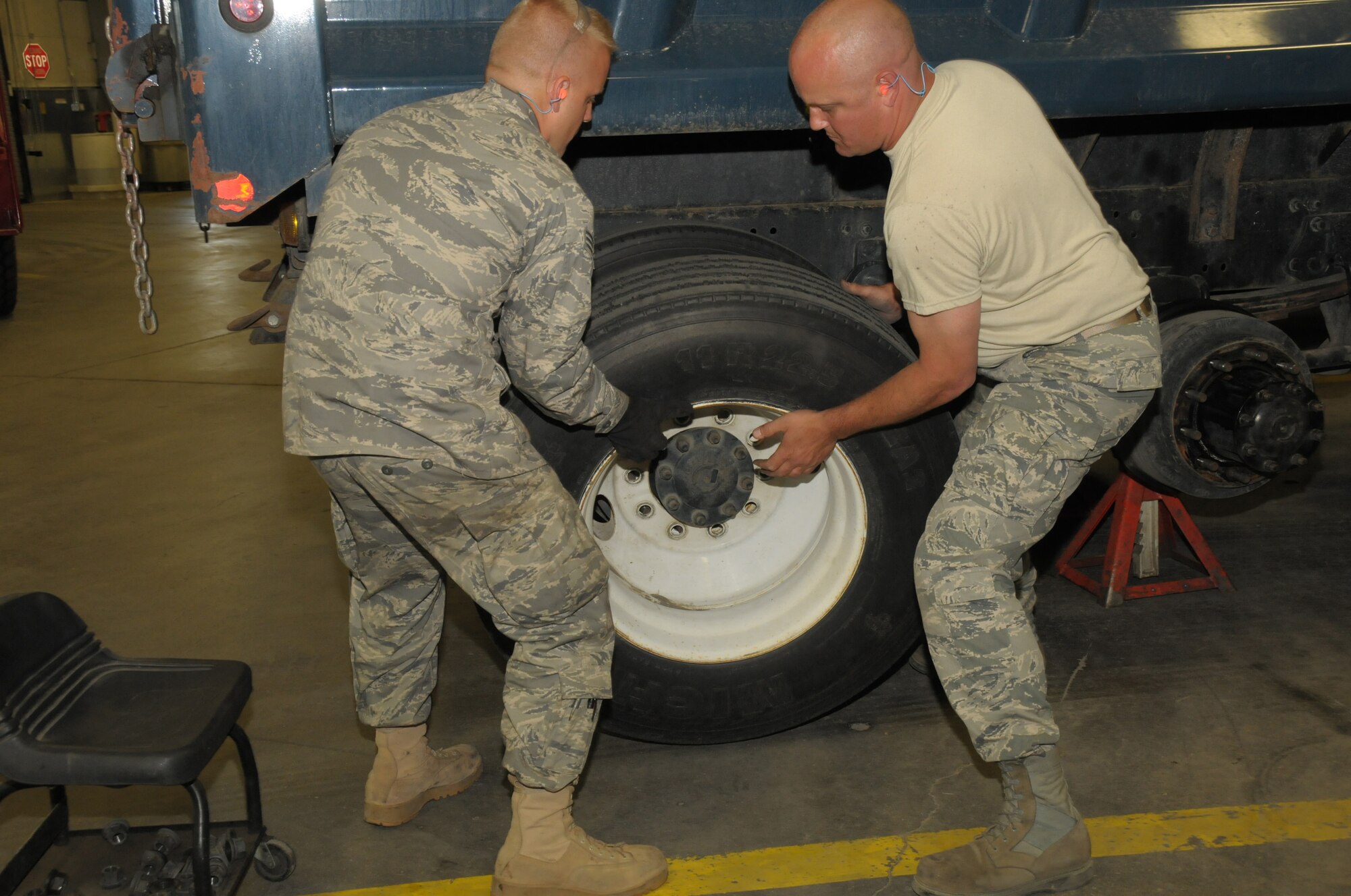Senior Airman Tobias Burrier and Staff Sergeant Jeffery Strong from Vehicle Maintenance, 146th Logistics Readiness Squadron, 146th Airlift Wing, Channel Islands Air National Guard Station, Calif. work together to remove a tire from a five-ton truck during an annual training deployment to Joint Base Elmendorf-Richardson, Anchorage, Alaska on June 8, 2011. The Air Terminal Operations Squadron, Logistics Readiness Squadron,and the Security Forces Squadron, from the 146AW, traveled to Alaska to complete their respective annual training requiremens. (Photo by Tech. Sgt. Alex Koenig)