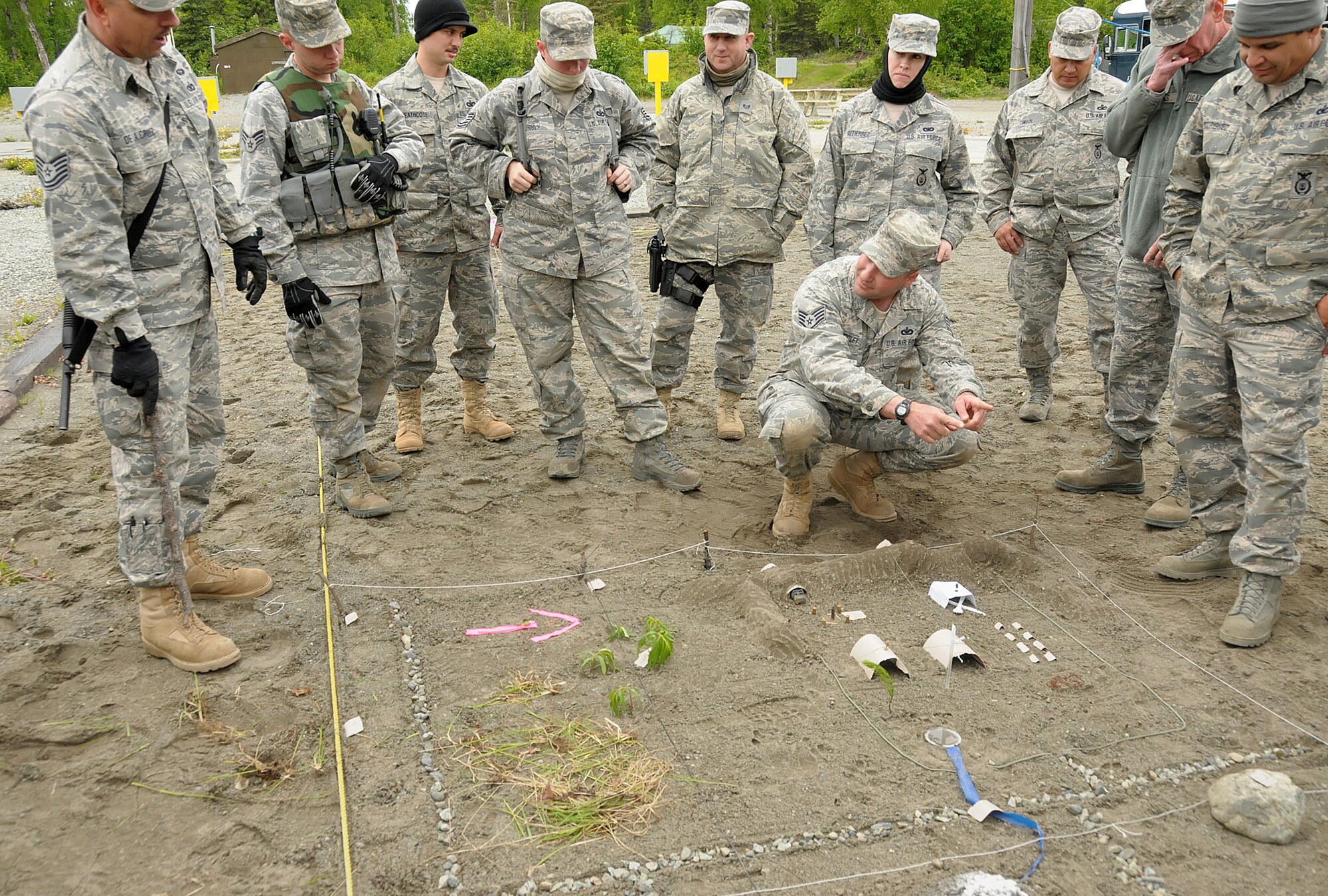 Technical Sergeant Marco De La Cruz, a member of the 146th Security Forces Squadron, 146th Airlift Wing, Channel Islands Air National Guard Station, Calif. instructs Security Forces members on how to properly use a sand table, a three-dimensional version of a grid map. The table helps to illustrate how maps are a vital aid when traversing rough terrain as well as obtaining intelligence on a possible target. (Photo by Tech. Sgt. Alex Koenig)