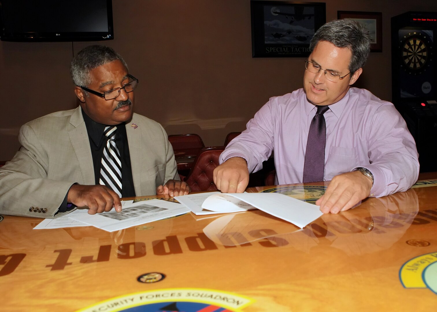 Mark Tharp (right), 802nd Force Support Squadron sustainment services flight chief, reviews club policies with Charles Mullins, 802nd FSS, June 6 at the Gateway Club. Mr. Tharp was recently named the Air Force 2010 Force Support Manager of the Year. (U.S. Air Force photo/Tony Morano)