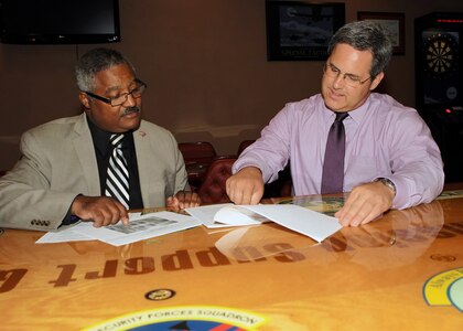 Mark Tharp (right), 802nd Force Support Squadron sustainment services flight chief, reviews club policies with Charles Mullins, 802nd FSS, June 6 at the Gateway Club. Mr. Tharp was recently named the Air Force 2010 Force Support Manager of the Year. (U.S. Air Force photo/Tony Morano)