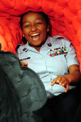 Junior Reserve Officer Training Corps Cadet Staff Sgt. Vanessa Aragon from Higgins High School in Marrero, La., laughs as her fellow cadets help her out of a life raft during the JROTC career day at Hoban Hall on Barksdale Air Force Base, La., June 9. JROTC cadets from more than 100 schools in five states visited Barksdale, home of Air Force Global Strike Command, to learn about numerous Air Force careers from subject matter experts. (U.S. Air Force photo/Senior Airman Joanna M. Kresge) 
