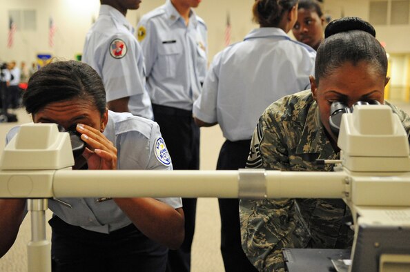 Junior Reserve Officer Training Corps Cadet Tech. Sgt. Tiffany Smith from Bossier High School in Bossier City, La., examines blood cells in a microscope with Senior Master Sgt. Shanece Johnson, 2nd Medical Support Squadron, during the JROTC career day at Hoban Hall on Barksdale Air Force Base, La., June 9. The goal of the career day was to give cadets a greater understanding of Air Force careers and culture. (U.S. Air Force photo/Senior Airman Joanna M. Kresge)