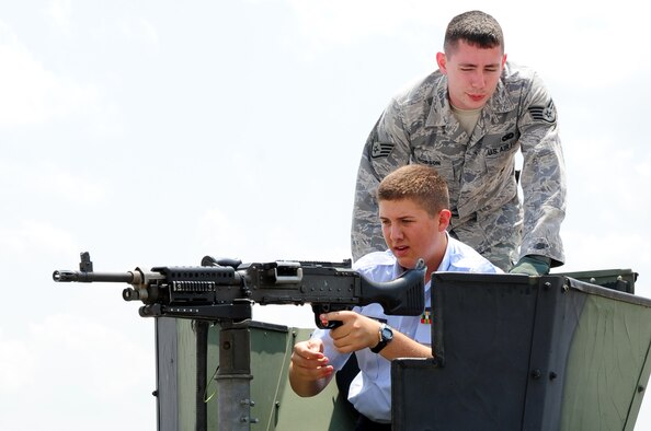 Staff Sgt. Derek Dobson, 2nd Security Forces Squadron, briefs Cadet Tech. Sgt. Jacob Griffin, South Panola High School, about the gunner position on a security forces HUMVEE during the Junior Reserve Officer Training Corps career day at Barksdale Air Force Base, La., June 9. JROTC cadets from more than 100 schools in five states visited Barksdale, home of Air Force Global Strike Command, to learn about numerous Air Force careers from subject matter experts. (U.S. Air Force photo/Senior Airman Joanna M. Kresge) 