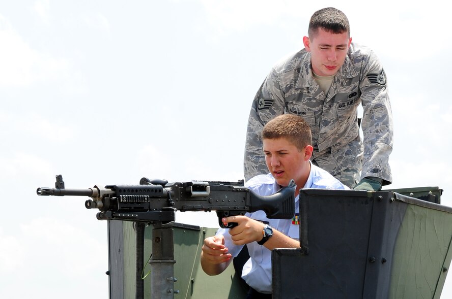 Staff Sgt. Derek Dobson, 2nd Security Forces Squadron, briefs Cadet Tech. Sgt. Jacob Griffin, South Panola High School, about the gunner position on a security forces HUMVEE during the Junior Reserve Officer Training Corps career day at Barksdale Air Force Base, La., June 9. JROTC cadets from more than 100 schools in five states visited Barksdale, home of Air Force Global Strike Command, to learn about numerous Air Force careers from subject matter experts. (U.S. Air Force photo/Senior Airman Joanna M. Kresge) 