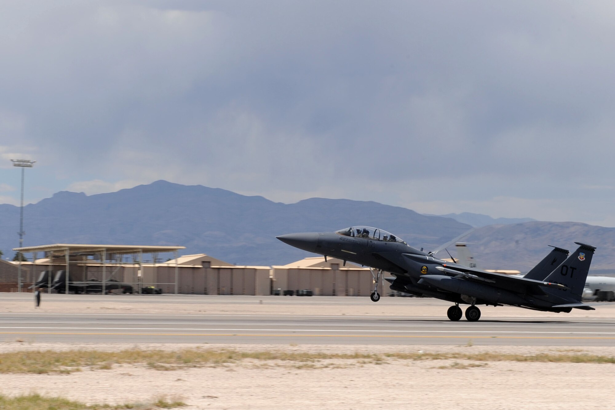 NELLIS AIR FORCE BASE, Nev.-- A F-15 Strike Eagle assigned the U.S. Air Force Weapons School returns from the Nevada Test and Training Range during the Mission Employment phase, June 8, 2011. More than 5,000 personnel are involved in the final phase of the Weapons School graduate course, resulting in 89 students from 21 separate combat specialties graduating as U.S. Air Force Weapons Officers. (U.S. Air Force photo by Staff Sgt. Taylor Worley)