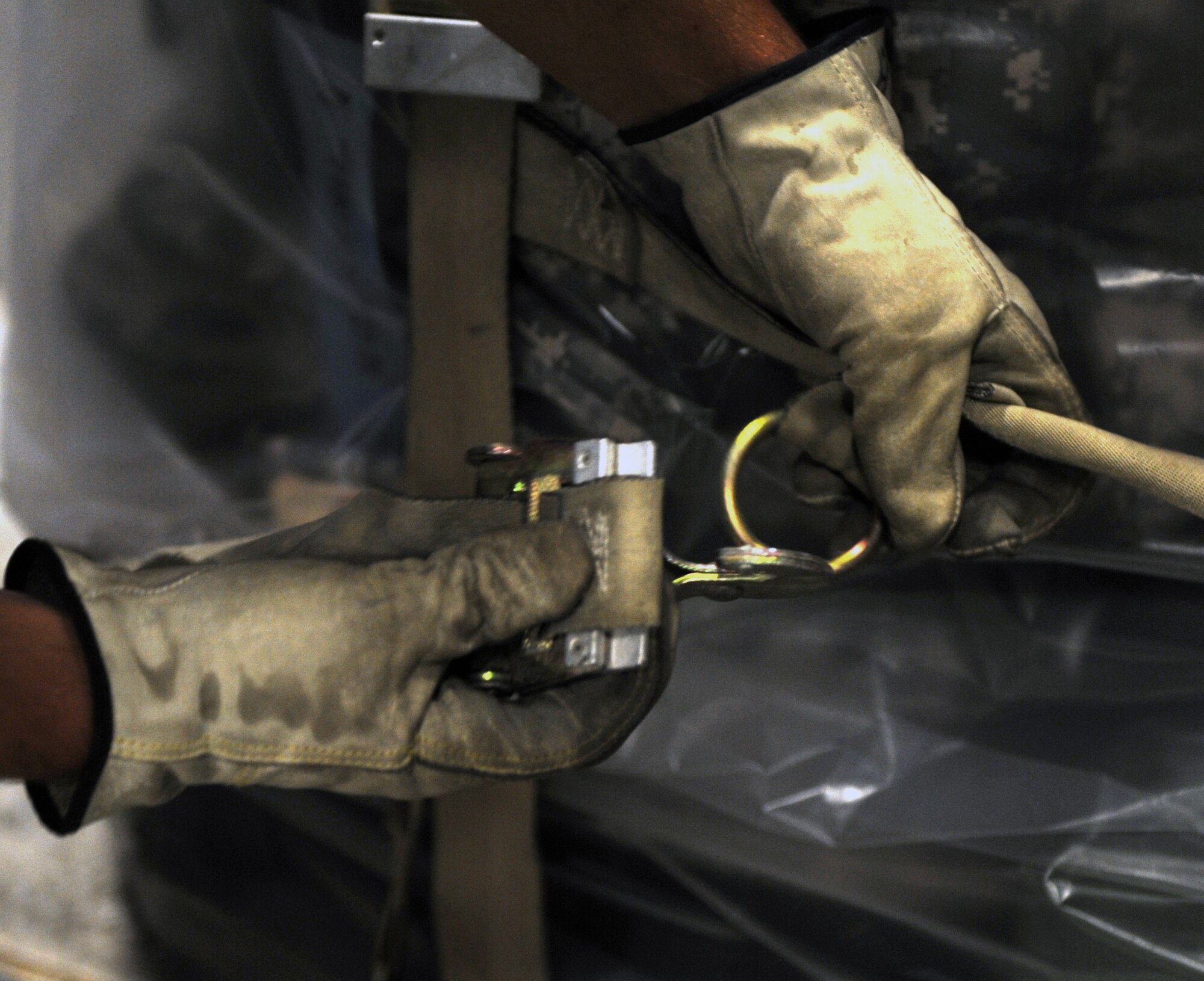 A 19th Logistics Readiness Squadron Airman tightens down a strap on a pallet for transport during an operational readiness exercise June 4, 2011, at Little Rock Air Force Base, Ark. The purpose of the exercise is to prepare Little Rock Airmen for the upcoming operational readiness inspection in October. (U.S. Air Force photo by Airman 1st Class Rusty Frank)