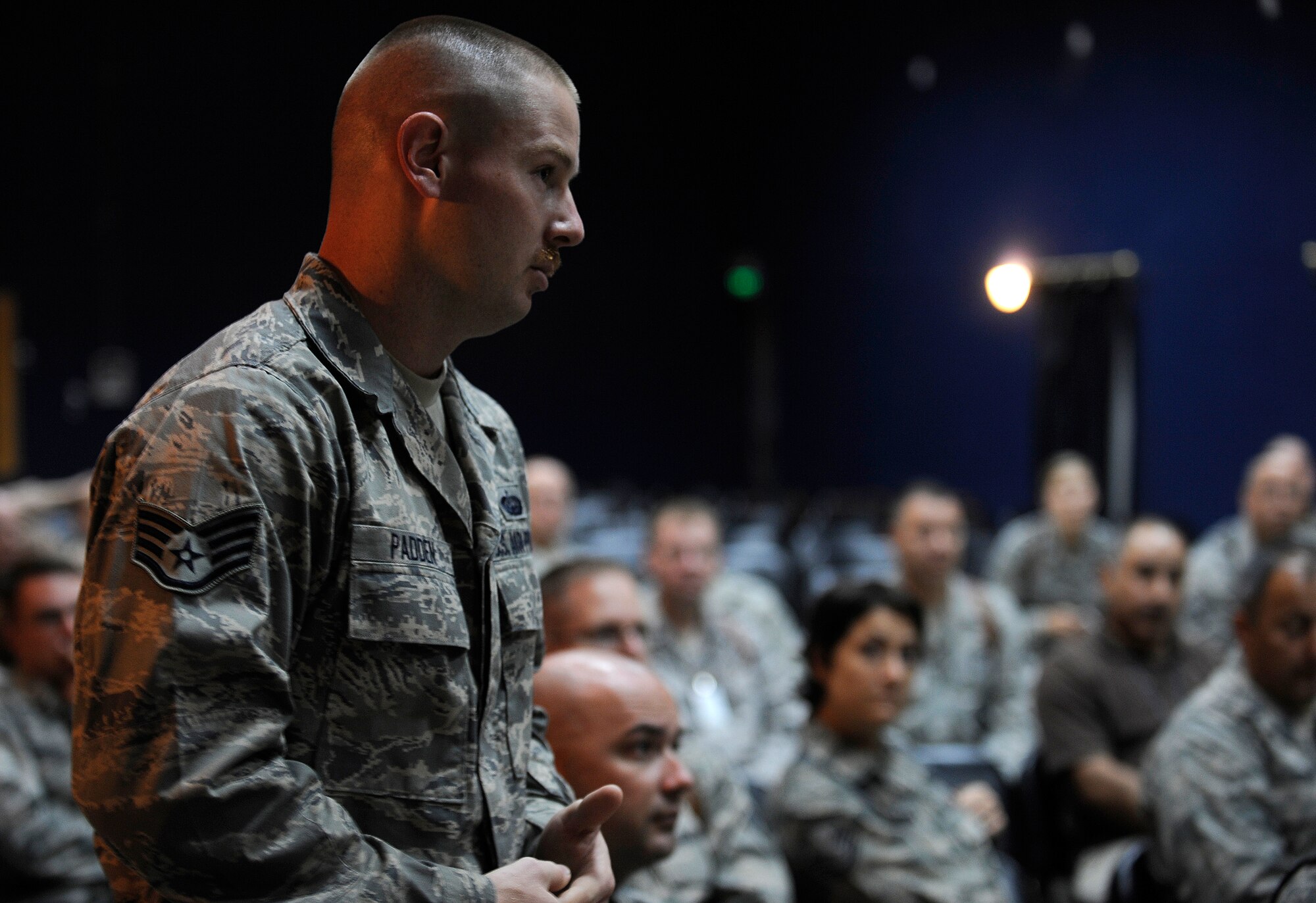 CAMP TAJI, Iraq -- Kristopher Padden, Detachment 1 base transition team communications advisor, asks Brig. Gen. Anthony Rock, Iraq Training and Advisory Team - Air director, about post-December possibilities during a commander's call at the base theater June 8. Detachment 1 is one of six BTTs aiding Iraqis at Kirkuk, New Al-Muthana, Tirkrit, Balad and Ali bases. The teams facilitate training with firefighters, security forces, communications and other critical skills needed to sustain air base operations as American military forces depart. Sergeant Padden is deployed from Whiteman Air Force Base, Mo., and is a Caledonia, Miss., native. (U.S. Air Force/Tech. Sgt. Jason Lake)