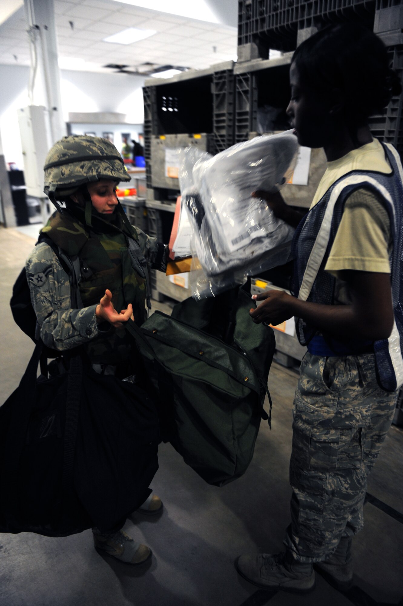 Airman 1st Class Jessica Barnes, a 19th Civil Engineer Squadron combat engineer, receives her chemical boots during an operational readiness exercise June 4, 2011, at Little Rock Air Force Base, Ark. The purpose of the exercise is to prepare Little Rock Airmen for the upcoming operational readiness inspection in October. (U.S. Air Force photo by Airman 1st Class Rusty Frank)