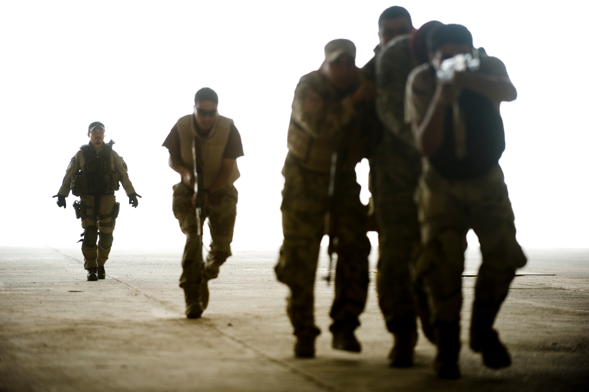 Special Agent Masashi Yamazaki (left) instructs Iraqi security forces members on personal security operations at New Al Muthana Air Base, Iraq, June 1. The Iraqis were participating in personal security operations training to develop the skills needed to protect their leaders in future operations. (U.S. Air Force photo/Staff Sgt. Levi Riendeau)