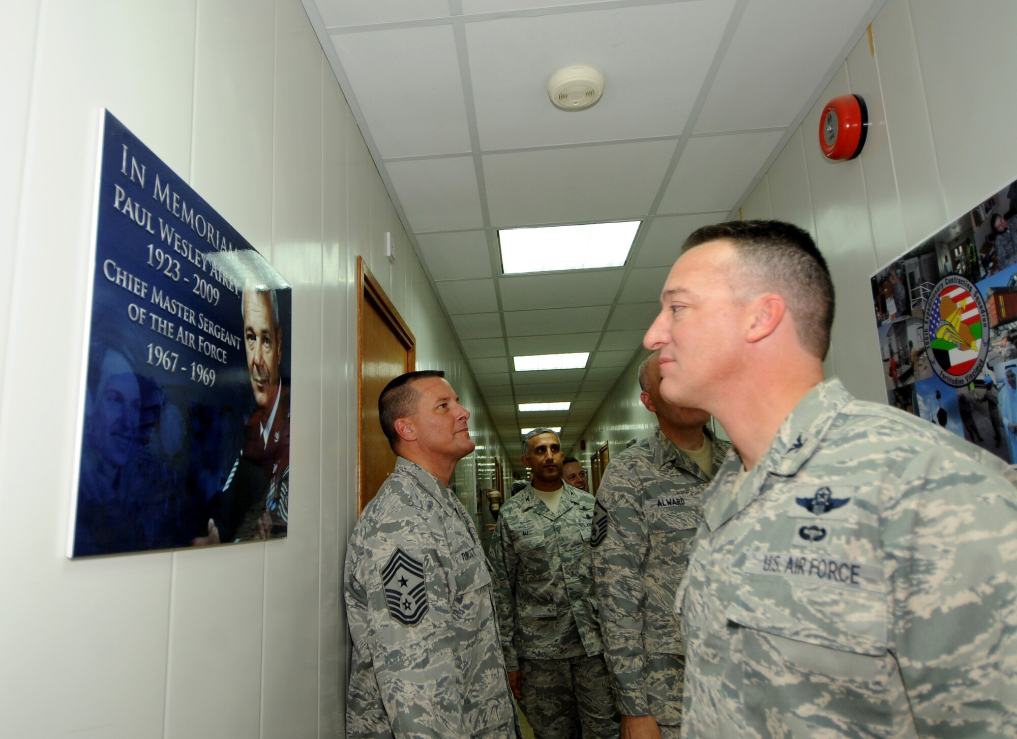 Col. Patrick Mordente, 386th Air Expeditionary Wing commander, right, Chief Master Sgt. Richard Turcotte, 386th AEW command chief, left, and other members of 386th leadership tour Building 353, which became Airey Hall June 7 in honor of Chief Master Sgt. Paul Wesley Airey, the first chief master sergeant of the Air Force. (U.S. Air Force photo by Senior Airman Cynthia Spalding)