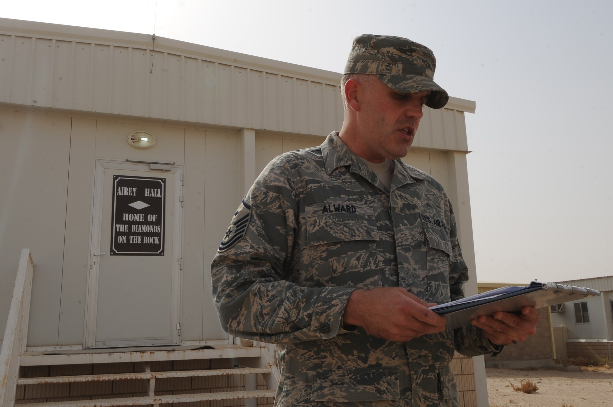 Master Sgt. Travis Alward, 386th Expeditionary Security Forces Squadron first sergeant, addresses members of the 386th Air Expeditionary Wing June 7 during a dedication of Building 353, which is now named Airey Hall in honor of Chief Master Sgt. Paul Wesley Airey, the first chief master sergeant of the Air Force. (U.S. Air Force photo by Senior Airman Cynthia Spalding)