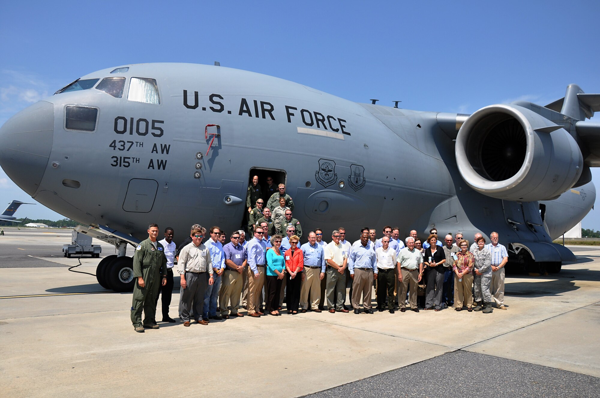 A civic leader group sponsored by the 315th Airlift Wing and visiting 908th Airlift Wing from Maxwell Air Force Base, Ala. posed for a group photo along with Col. Brett Clark, 908 AW commander, and members of his aircrew and team in front of a Charleston C-17 at Joint Base Charleston June 9, 2011. Inside the aircraft, members of the 315th Aeromedical Evacuation Squadron demonstrated the aeromedical capabilities of the Globemaster III. Aircrew from the 300th Airlift Squadron gave them a tour of the cargo bay and the flight deck. (Air Force photo by Michael Dukes)