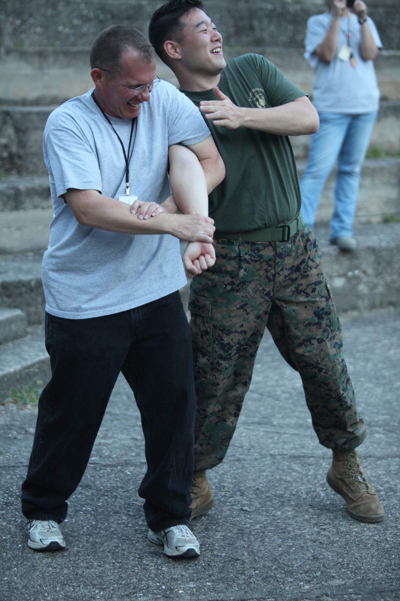 CAMP PEPELISHTE, Macedonia – Chief Master Sgt. Joshua Mills, 3rd Air Force Surgeon General’s Office chief, U.S. Air Forces in Europe medical logistics functional manager and senior Air Force enlisted advisor for Medical Training Exercise in Central and Eastern Europe 11, executes a proper Marine Corps Martial Arts arm lock on Marine Cpl. Eric Ahn, 4th Marine Logistics Group, Personnel and Retrieval Processing Company, PRP specialist, out of Anacostia, Washington, D.C., during MCMAP training led by Marine Staff Sgt. Tresor Mbunker, 4th MLG, PRP, mortuary affairs staff noncommissioned officer in charge and a black belt Marine Corps Martial Arts instructor out of Smyrna, Ga., June 8.  MEDCEUR is an annual Chairman of the Joint Chiefs of Staff-sponsored regional and multilateral exercise and is designed to provide medical training and operational experience in a deployed environment for U.S. and partner nations. The countries participating in this year’s MEDCEUR are Macedonia, Montenegro, Bosnia and Herzegovina, Serbia, Slovenia and Norway.  The exercise will include both classroom and hands-on training and run until June 15.  (Marine Corps photos/Lance Cpl. Zach Altemus)