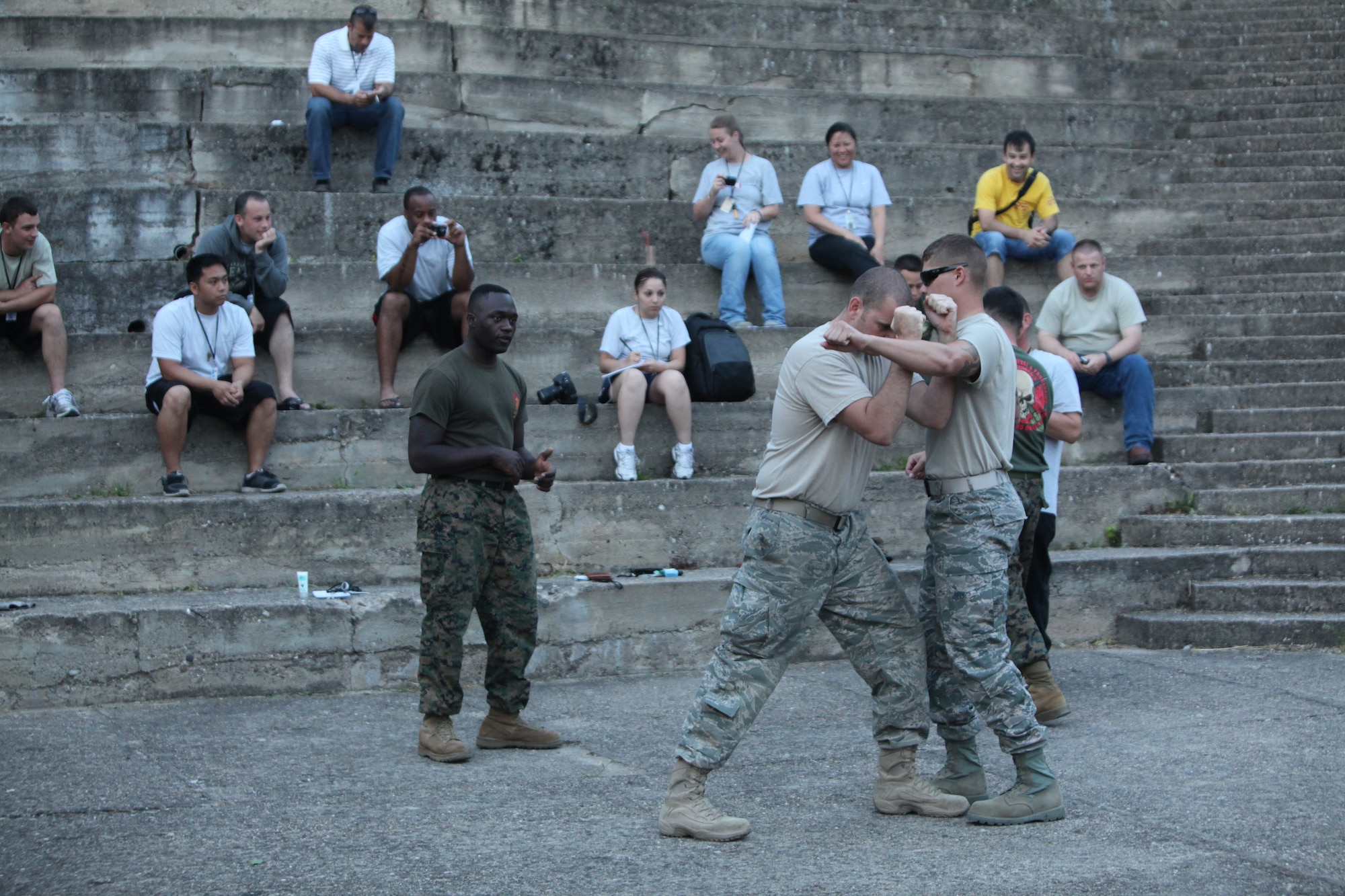 CAMP PEPELISHTE, Macedonia – Two Airmen attending the 2011 Medical Training Exercise in Central and Eastern Europe execute Marine Corps Martial Arts techniques in a MCMAP class led by U.S. Marine Staff Sgt. Tresor Mbunker, 4th Marine Logistics Group, Personnel and Retrieval Processing Company, mortuary affairs staff noncommissioned officer in charge and a black belt Marine Corps Martial Arts instructor out of Smyrna, Ga., June 8.  The Marines came to Macedonia for MEDCEUR 2011 to teach foreign military services how to conduct mortuary affairs. MEDCEUR is an annual Chairman of the Joint Chiefs of Staff-sponsored regional and multilateral exercise and is designed to provide medical training and operational experience in a deployed environment for U.S. and partner nations. The countries participating in this year’s MEDCEUR are Macedonia, Montenegro, Bosnia and Herzegovina, Serbia, Slovenia and Norway.  The exercise will include both classroom and hands-on training and run until June 15. (Marine Corps photo/Lance Cpl. Zach Altemus)