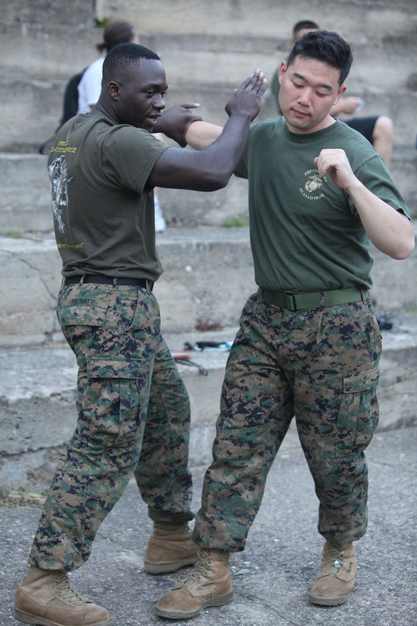 CAMP PEPELISHTE, Macedonia – U.S. Marine Staff Sgt. Tresor Mbunker, the mortuary affairs, 4th Marine Logistics Group, Personnel and Retrieval Processing Company, mortuary affairs staff noncommissioned officer in charge and a black belt Marine Corps Martial Arts instructor out of Smyrna, Ga., demonstrates MCMAP moves on Cpl. Eric Ahn, 4th MLG, PRP specialist,out of Anacostia, Washington, D.C., for spectators and students June 8.  The Marines came to Macedonia for Medical Training Exercise in Central and Eastern Europe 2011 to teach foreign military services how to conduct mortuary affairs. MEDCEUR is an annual Chairman of the Joint Chiefs of Staff-sponsored regional and multilateral exercise and is designed to provide medical training and operational experience in a deployed environment for U.S. and partner nations. The countries participating in this year’s MEDCEUR are Macedonia, Montenegro, Bosnia and Herzegovina, Serbia, Slovenia and Norway.  The exercise will include both classroom and hands-on training and run until June 15. (U.S. Marine Corps/Lance Cpl. Zach Altemus)