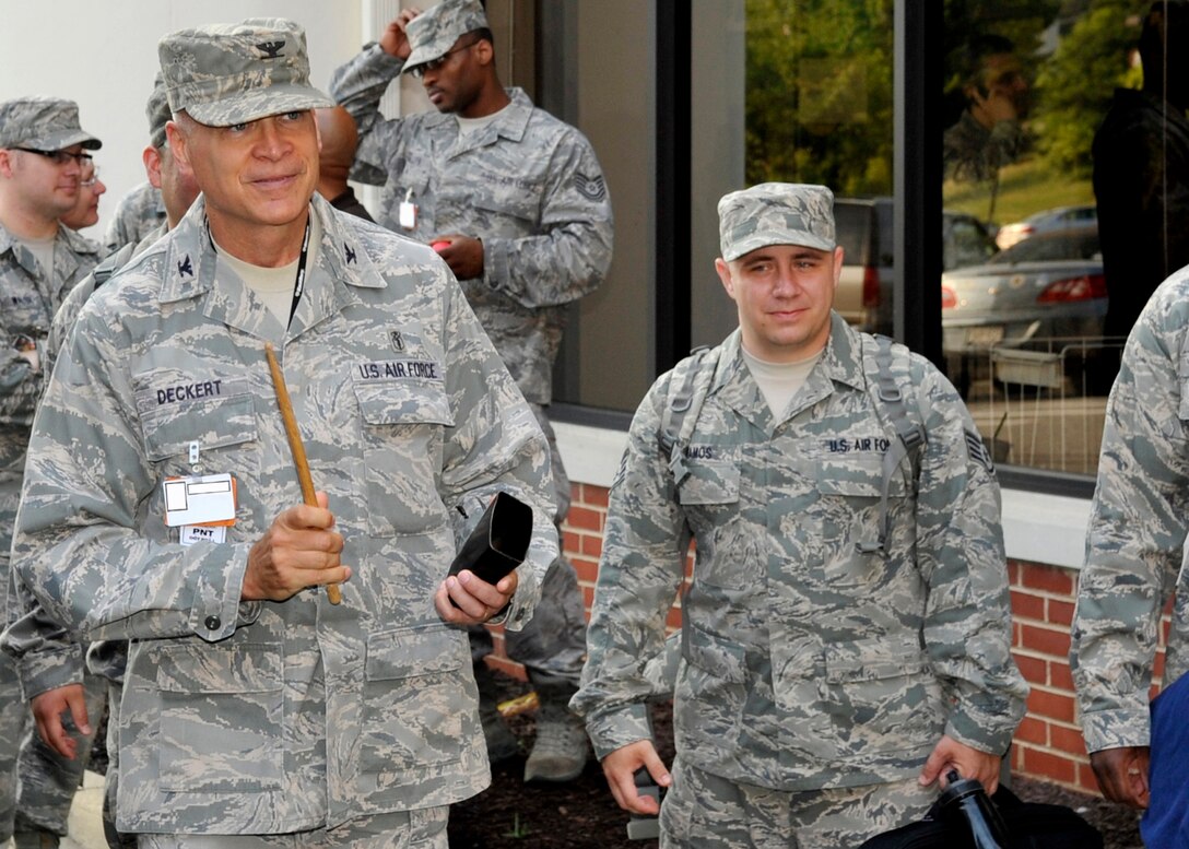 Colonel Brian Deckert, 779th Medical Group deputy commander, gives deploying medical personnel one last taste of 'more cowbell' as they board a bus Friday, June 10. All wing and group leadership were there to bid their troops farewell and wish them luck. (U.S. Air Force photo illustration/Senior Airman Laura Turner)