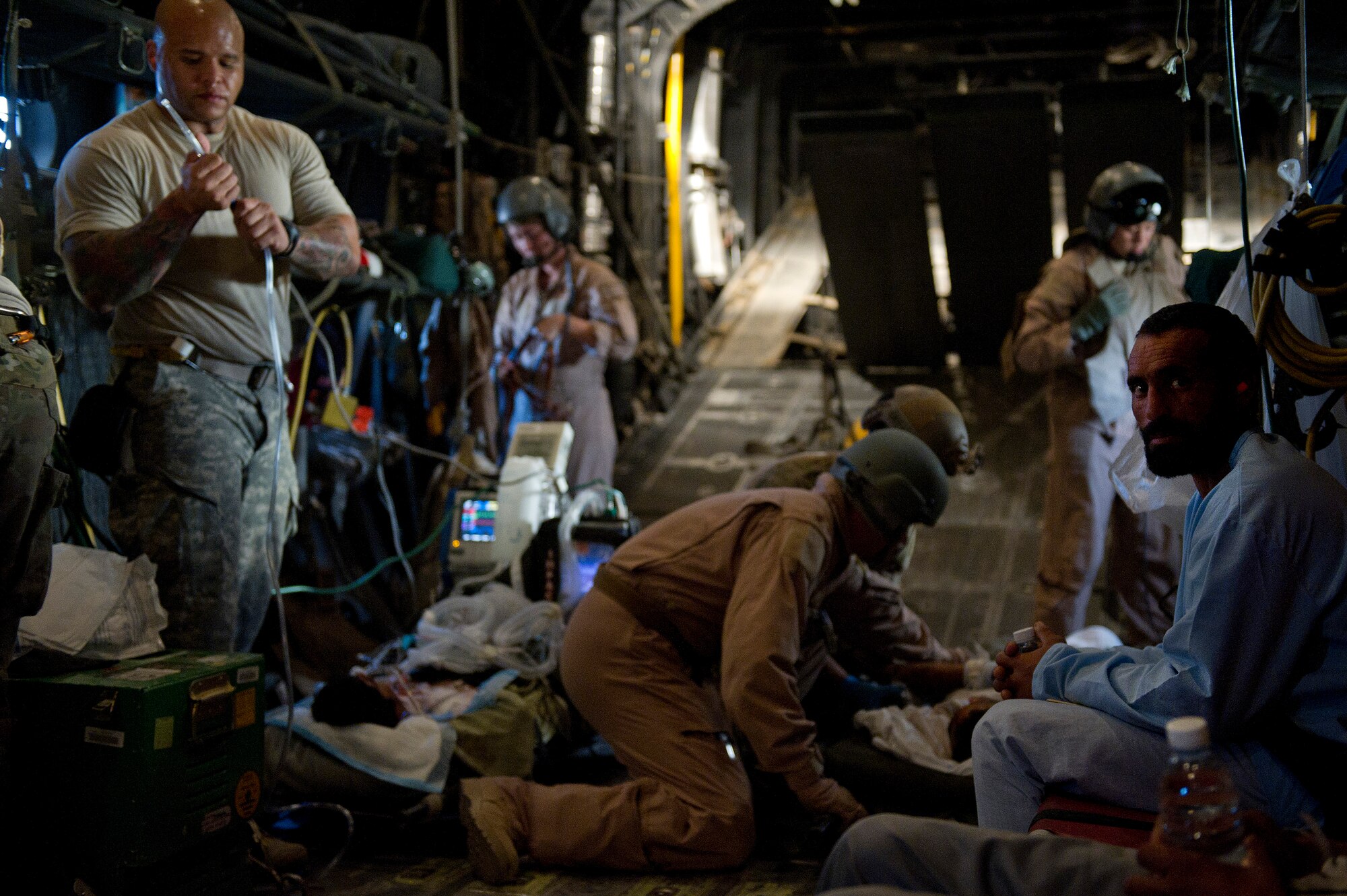 Members of the 76th and 46th Expeditionary Rescue Squadron tend to and transport wounded Afghan nationals on an HC-130P Hercules during a casualty evacuation mission. Members of the 76th and 46th ERQS are responsible for conducting combat search and rescue as well as personnel recovery missions in Afghanistan and assist with CASEVAC missions when available. (U.S. Air Force photo/Master Sgt. Adrian Cadiz)