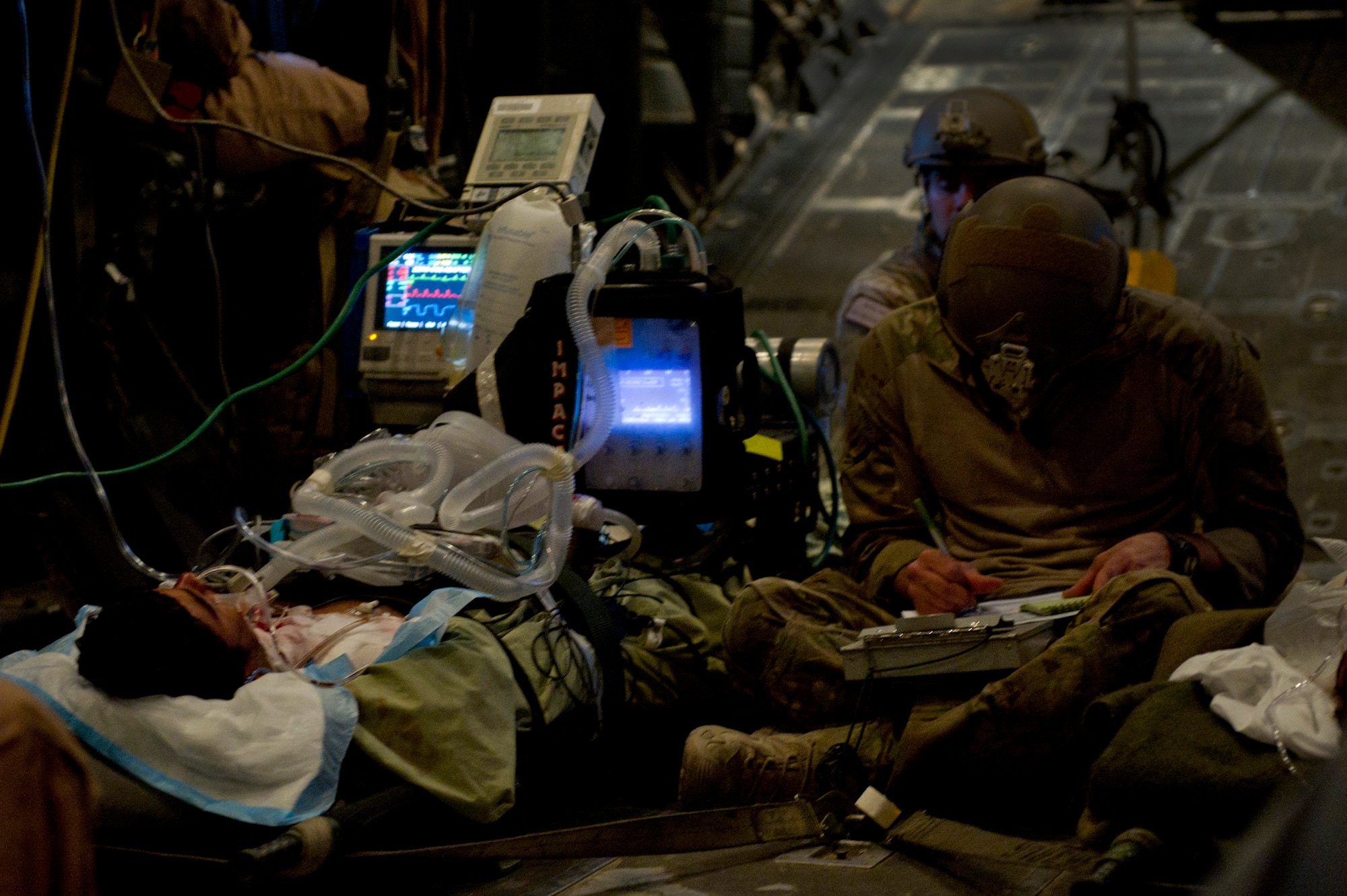 Senior Airman Steve Reibitz, 46th Expeditionary Rescue Squadron pararescuemen, documents medical data of a wounded Afghan National Security Force member aboard an HC-130P Hercules assigned to the 76th ERQS during a casualty evacuation mission. Members of the 46th and 76th ERQS are responsible for conducting combat search and rescue as well as personnel recovery missions in Afghanistan and assist with CASEVAC missions when available. (U.S. Air Force photo/Master Sgt. Adrian Cadiz)