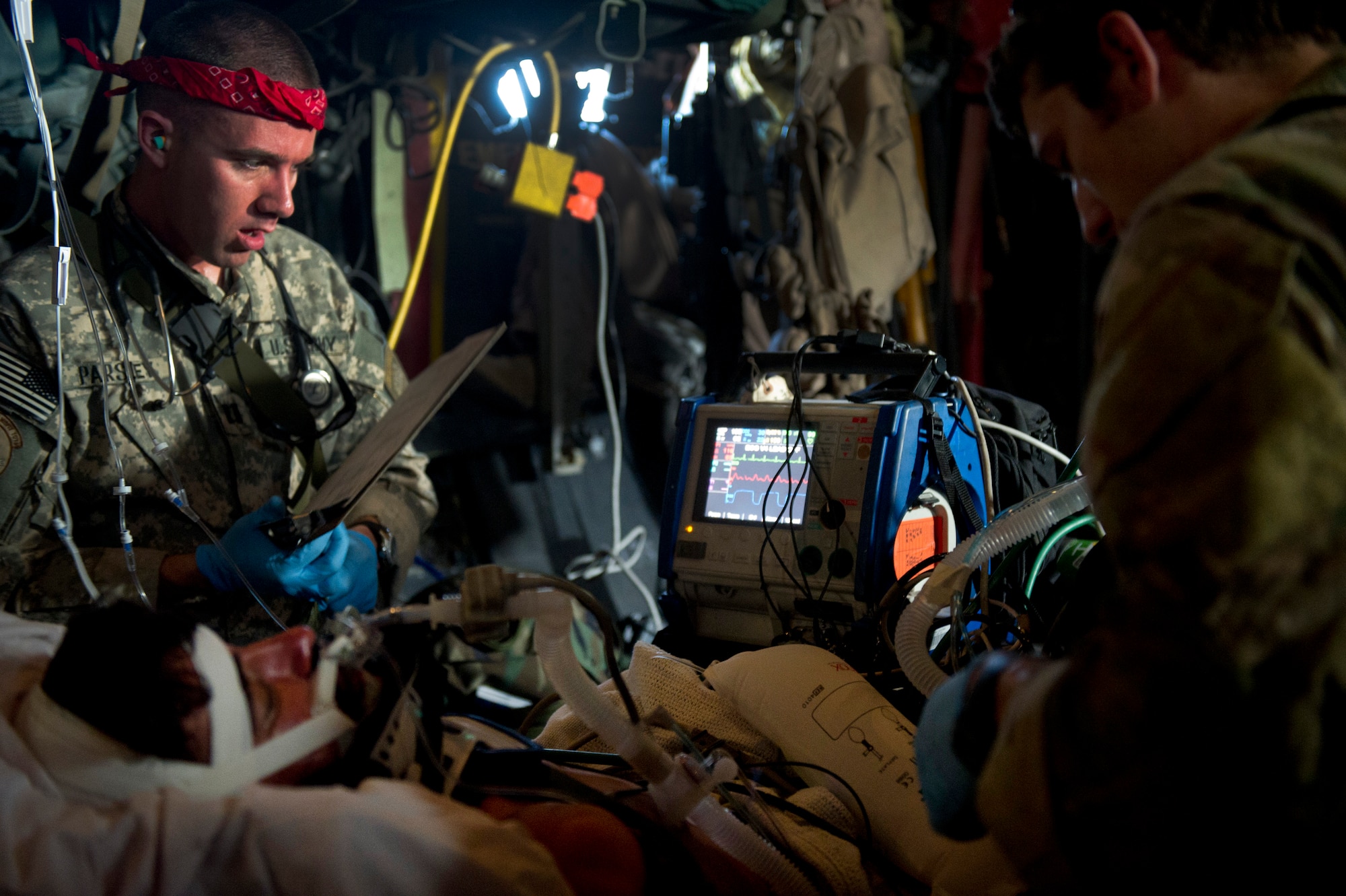 Army Capt. Robert Parsley, 76th Expeditionary Rescue Squadron critical care nurse, reads the vital signs of a wounded Afghan National Security Force member as he takes the patients blood pressure on an HC-130P Hercules assigned to the 76th ERQS during an aeromedical transport mission. Members of the 46th and 76th ERQS are responsible for conducting combat search and rescue as well as personnel recovery missions in Afghanistan and assist with CASEVAC missions when available. (U.S. Air Force photo/Master Sgt. Adrian Cadiz)