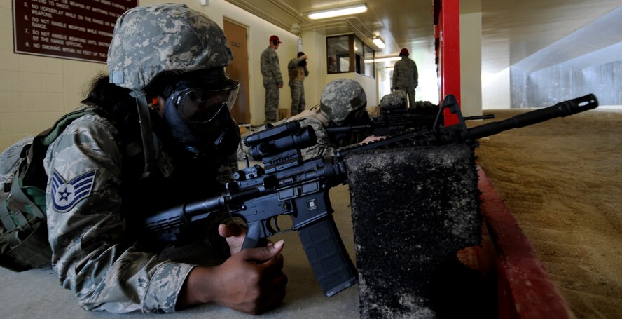 A qualifying Airman awaits the command of "fire" during the gas mask portion of the qualification at the 18th Security Forces Squadron's Combat Arms firing range May 24. During the timed qualification, the gas mask portion tests the Airmen's abilities to fire even in a contaminated environment. (U.S. Air Force photo/ Airman 1st Class Maeson L. Elleman)