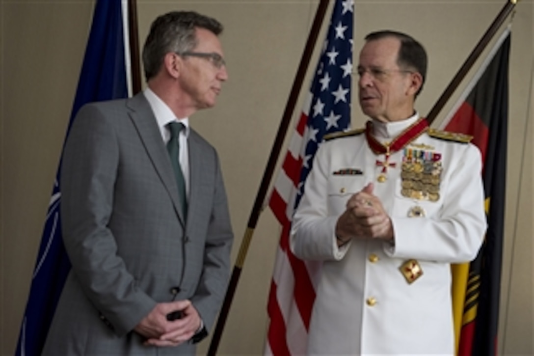 Chairman of the Joint Chiefs of Staff Adm. Mike Mullen thanks German Minister of Defense Thomas de Maiziäre after receiving the German Order of Merit in Berlin, Germany, on June 9, 2011.  Mullen is on a seven-day trip visiting Egypt and Europe to meet with counterparts and leaders.  