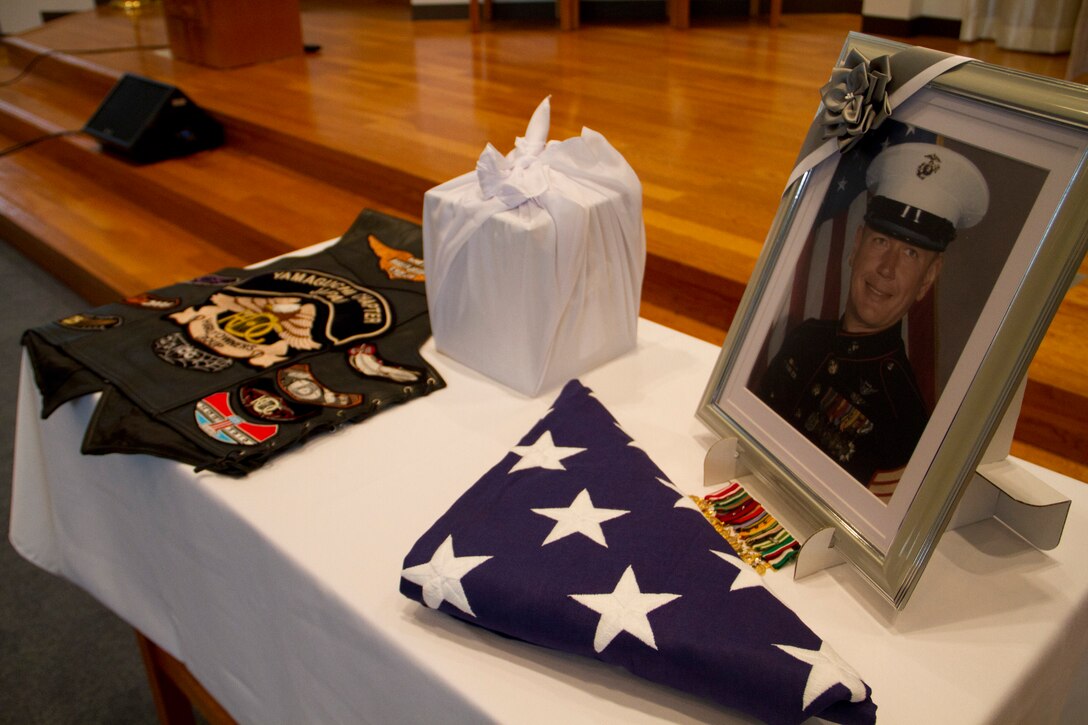 The photo of retired Sgt. Maj. Ken Runyan is put on display along with his medals and the American flag during his memorial service at the Marine Memorial Chapel here June 10. Runyan was buried at sea as his final request. He is survived by his wife and children.