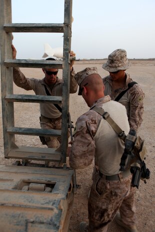 Cpl. Joshua L. Dunmire (left), from Fulton, Mo., Lance Cpl. Alcario J. Villa (middle), from Riverside, Calif., and Sgt. Dennis W. Ruff (right), from Eureka Springs, Ark., engineer equipment operators with 7th Engineer Support Battalion, 2nd Marine Logistics Group (Forward), set up a ramp to off load a multi-purpose tractor from a trailer June 11, 2011, aboard Forward Operating Base Geronimo, Afghanistan.   The engineers are currently repairing two major routes in Marjah for Marines with 1st Battalion, 9th Marine Regiment, 2nd Marine Division (Fwd.) who are conducting operations in the area in support of the International Security Assistance Force.