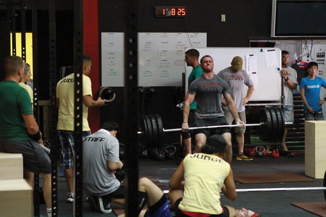 A competitor at the CrossFit Asia Regional competition dead lifts 315 pounds during the timed event at the CrossFit Asia gym in Okinawa City June 11.