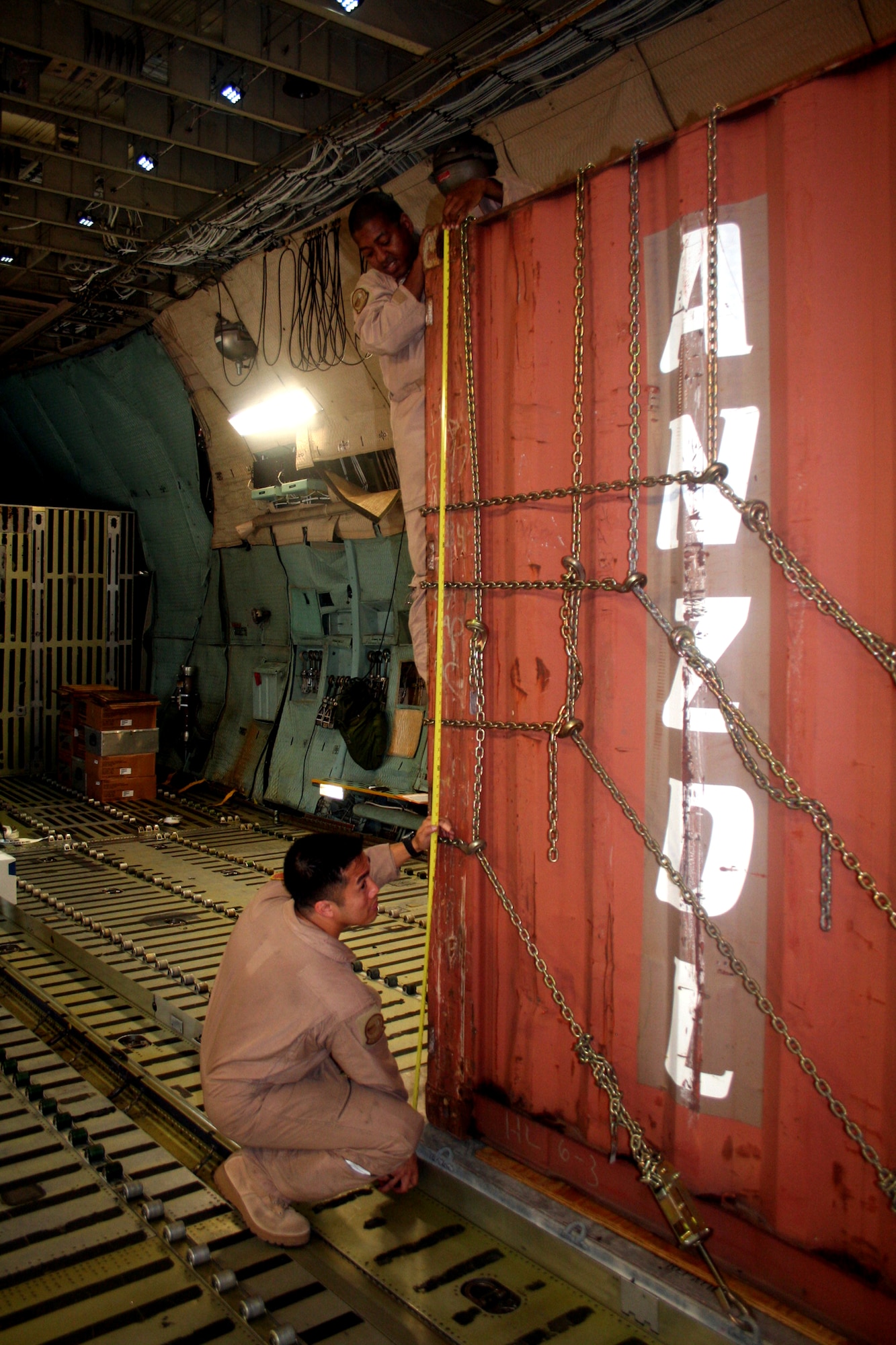Staff Sgts. Tramainn McKee and Angelo Dumanhog, both C-5 Galaxy loadmasters, work in a C-5M Super Galaxy on June 5, 2011, prior to departing for a direct delivery airlift mission through the Arctic Circle from Dover Air Force Base, Del., to Bagram Airfield, Afghanistan. Sergeants McKee and Dumanhog were among 14 crewmembers who flew the mission. They are from the 9th Airlift Squadron at Dover AFB.  (U.S. Air Force Photo/Master Sgt. Scott T. Sturkol)