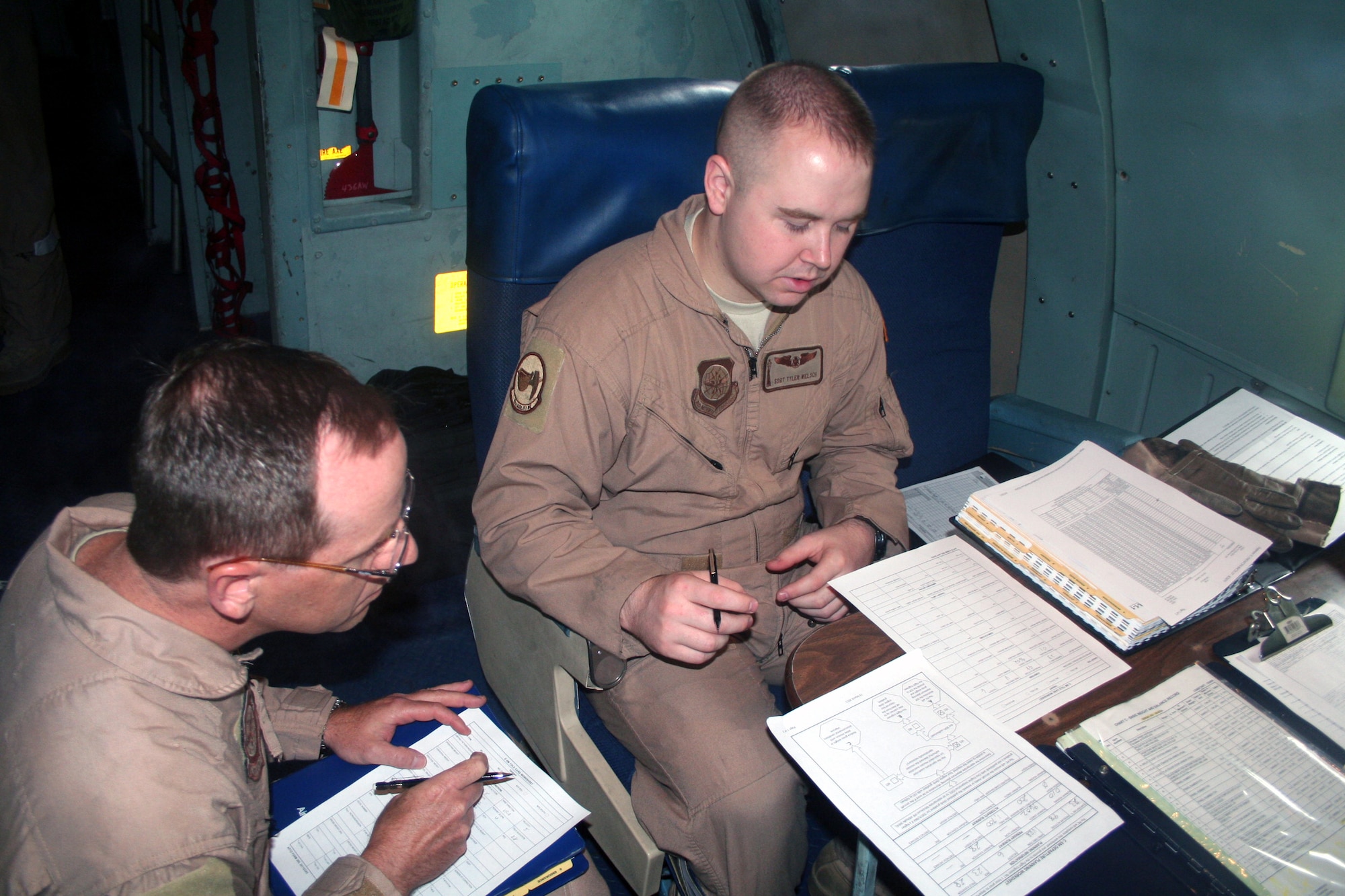 Master Sgt. Bradley Bronov and Staff Sgt. Tyler Welsch, both C-5 Galaxy flight engineers, work in a C-5M Super Galaxy on June 5, 2011, prior to departing for a direct delivery airlift mission through the Arctic Circle from Dover Air Force Base, Del., to Bagram Airfield, Afghanistan. Both Airmen were part of 14 crewmembers who flew the mission and both are from the 9th Airlift Squadron at Dover AFB.  (U.S. Air Force Photo/Master Sgt. Scott T. Sturkol)