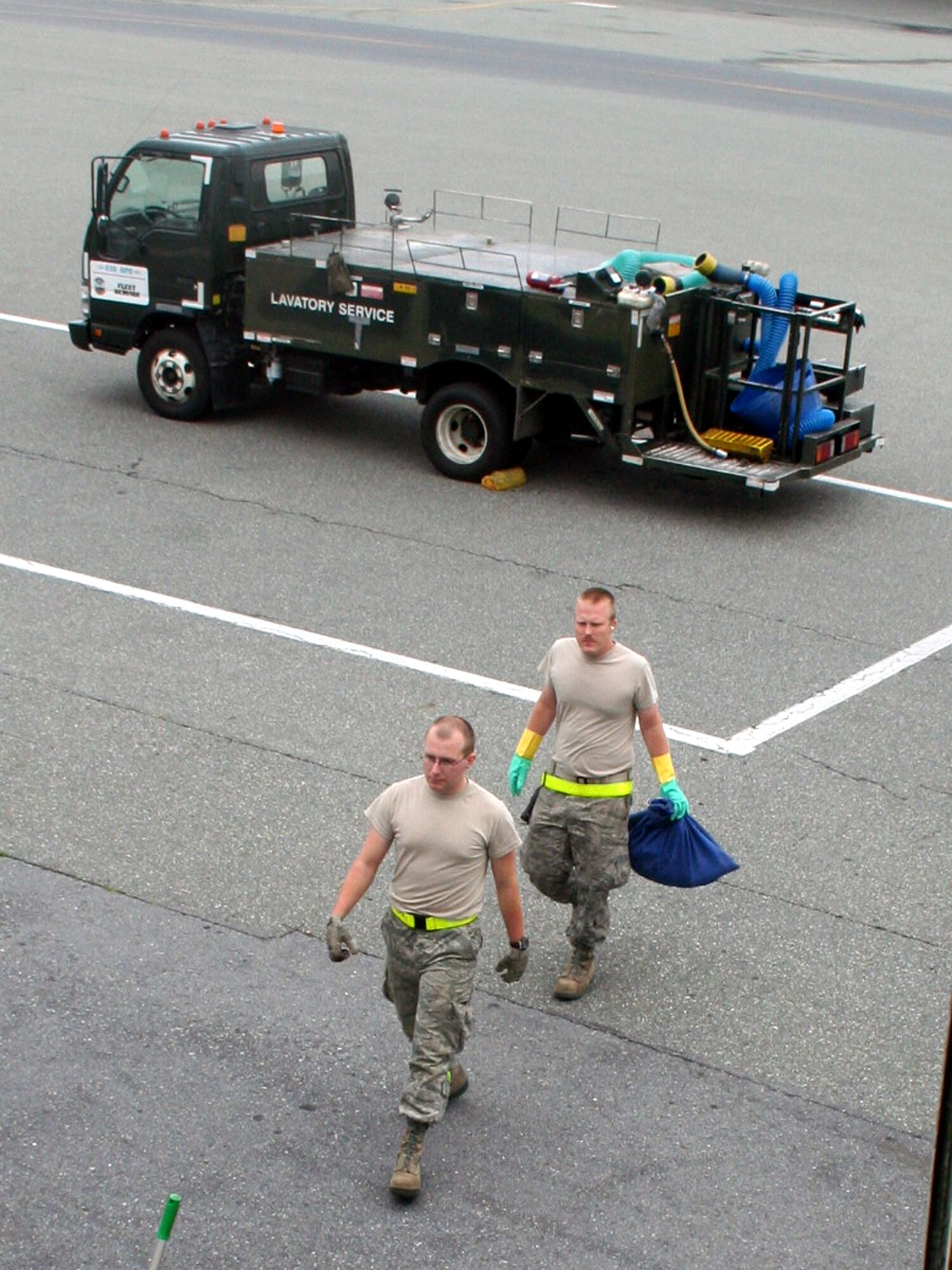 Airmen 1st Class Dustin Carlton and Brett Kiser, air transportation journeymen from the 436th Aircraft Aerial Port Squadron, walk to a C-5M Super Galaxy on June 5, 2011, to check on cargo prior to the plane's departure for a direct delivery airlift mission through the Arctic Circle from Dover Air Force Base, Del., to Bagram Airfield, Afghanistan. (U.S. Air Force Photo/Master Sgt. Scott T. Sturkol)