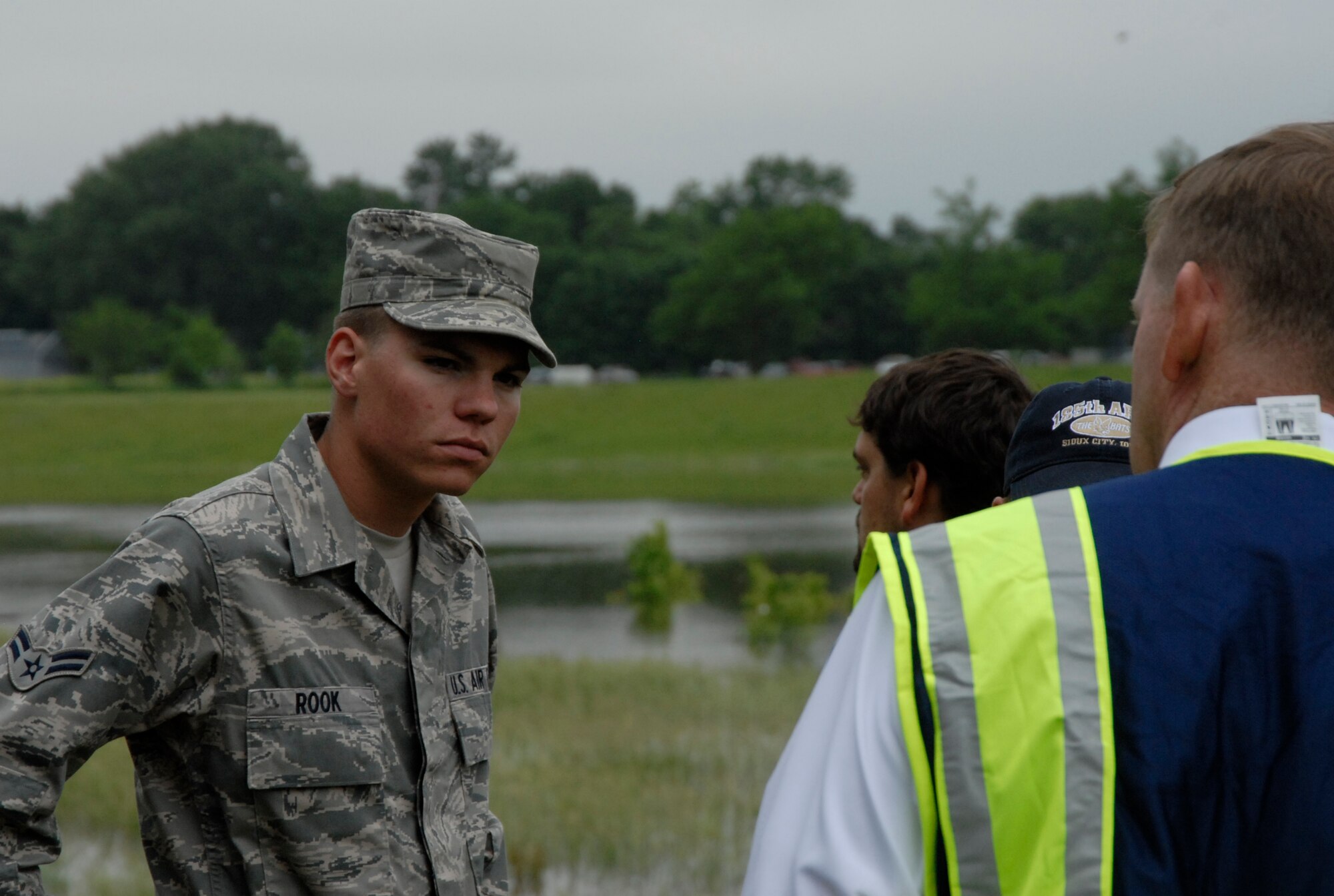 Airman 1st Class Devon Rook, a member of the 185th Air Refueling Wing, listens to Capt. Marti Reilly, an officer from the Sioux City Police Department, explain what to look for during flood patrol duties on June 10, 2011. The 185th will work along with the Army Corps of Engineers and the city of Sioux City to monitor the levees holding back the waters from the Missouri River. USAF Photo Staff Sgt. Rich Murphy, 185th Air Refueling Wing, Iowa Air National Guard (released) 