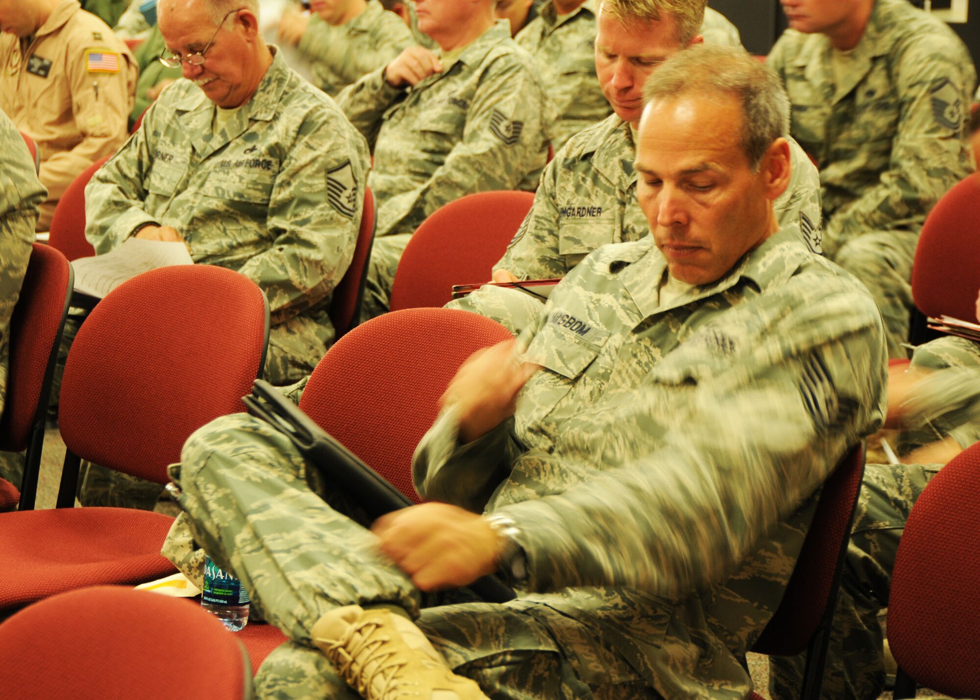 A recent deployment returnee, Tech. Sgt.  Kelly Hagbom, 919th Maintenance Squadron, reviews inprocessing paperwork in Duke Field’s deployment processing facility June 10.  Dozens of Duke Field reservists were attending an inprocessing briefing by a host of base support agencies focused on gradually reintegrating the Airmen back to home station service and civilian employment.  (U.S. Air Force photo/Dan Neely)