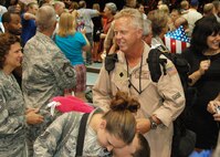 Inside a Hurlburt Field hangar, Senior Master Sgt. Tom Haddock, 711th Special Operations Squadron, smiles as gets his first glimpse of awaiting family members moments after he and dozens of fellow Duke Field reservists returned home June 10 from a wartime deployment.    Hundreds of family and military members from Duke and Hurlburt Fields were on hand for the Operation Homecoming event.   (U.S. Air Force photo/Dan Neely)
