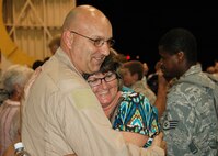 Inside a Hurlburt Field hangar, Master Sgt.  John Wood, 919th Logistics Readiness Squadron, hugs his wife, Angela, moments after he and dozens of fellow Duke Field reservists returned home June 8 from a wartime deployment.    Hundreds of family and military members from Duke and Hurlburt Fields were on hand for the Operation Homecoming event.   (U.S. Air Force photo/Dan Neely)