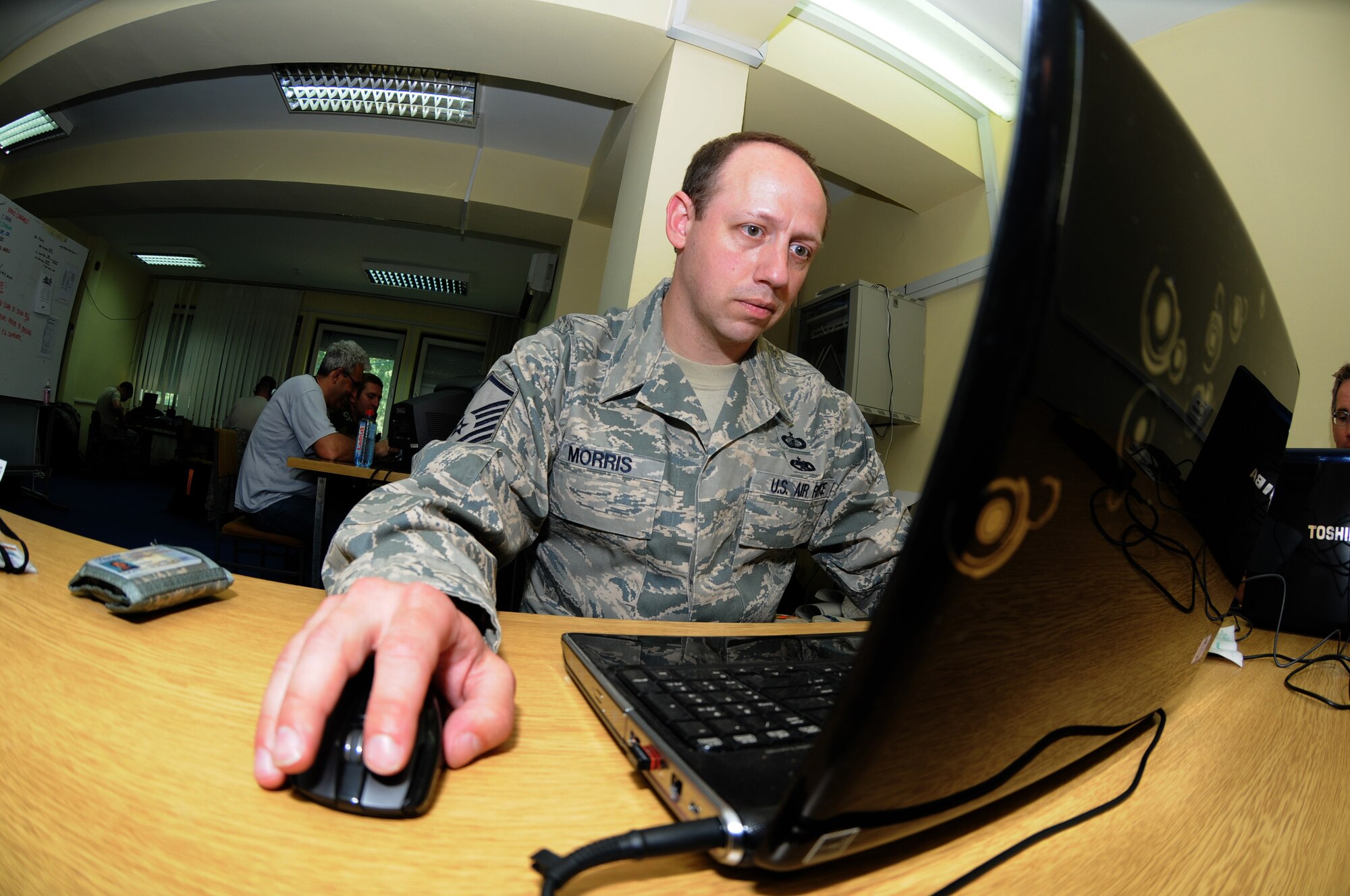 CAMP PEPELISHTE, Macedonia -- Master Sgt. Billy Morris, 3rd Air Force contingency operations contracting officer, performs a contract modification June 10 in support of the 2011 Medical Training Exercise in Central and Eastern Europe. The annual Chairman of the Joint Chiefs of Staff-sponsored regional and multilateral exercise, MEDCEUR is designed to provide medical training and operational experience in a deployed environment for U.S. and partner nations. The countries participating in this year's MEDCEUR are Macedonia, Montenegro, Bosnia and Herzegovina, Serbia, Slovenia and Norway. (U.S. Air Force photo/Staff Sgt. Julius Delos Reyes)