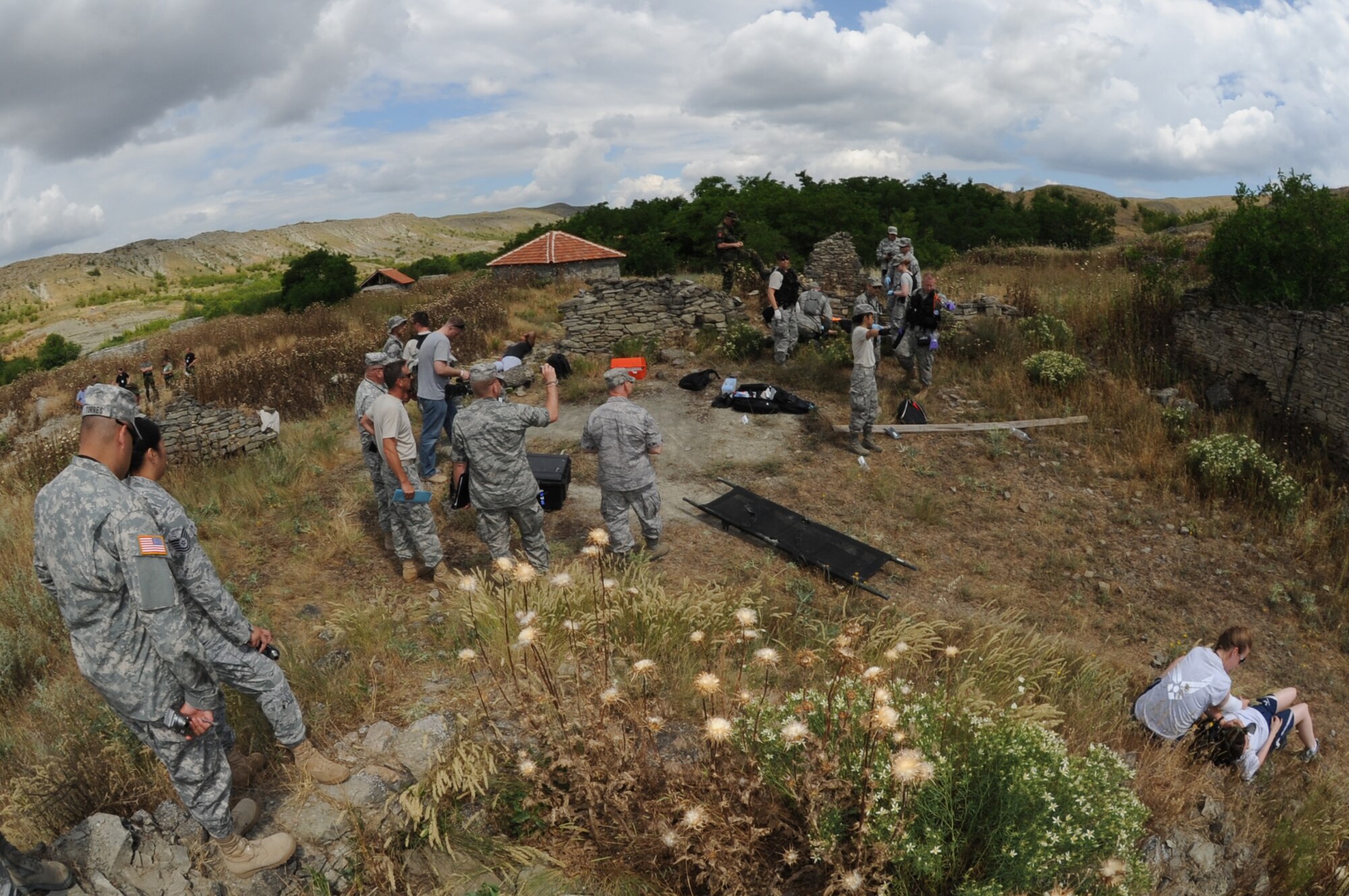 KRIVOLAK, Macedonia -- Instructors and distinguished visitors monitor the progress of 11 Airmen participating in the 2011 Medical Training Exercise in Central and Eastern Europe expeditionary Initial Contengiency Response Team day June 10. The annual Chairman of the Joint Chiefs of Staff-sponsored regional and multilateral exercise, MEDCEUR is designed to provide medical training and operational experience in a deployed environment for U.S. and partner nations. The countries participating in this year's MEDCEUR are Macedonia, Montenegro, Bosnia and Herzegovina, Serbia, Slovenia and Norway. (U.S. Air Force photo/Staff Sgt. Nadine Y. Barclay)