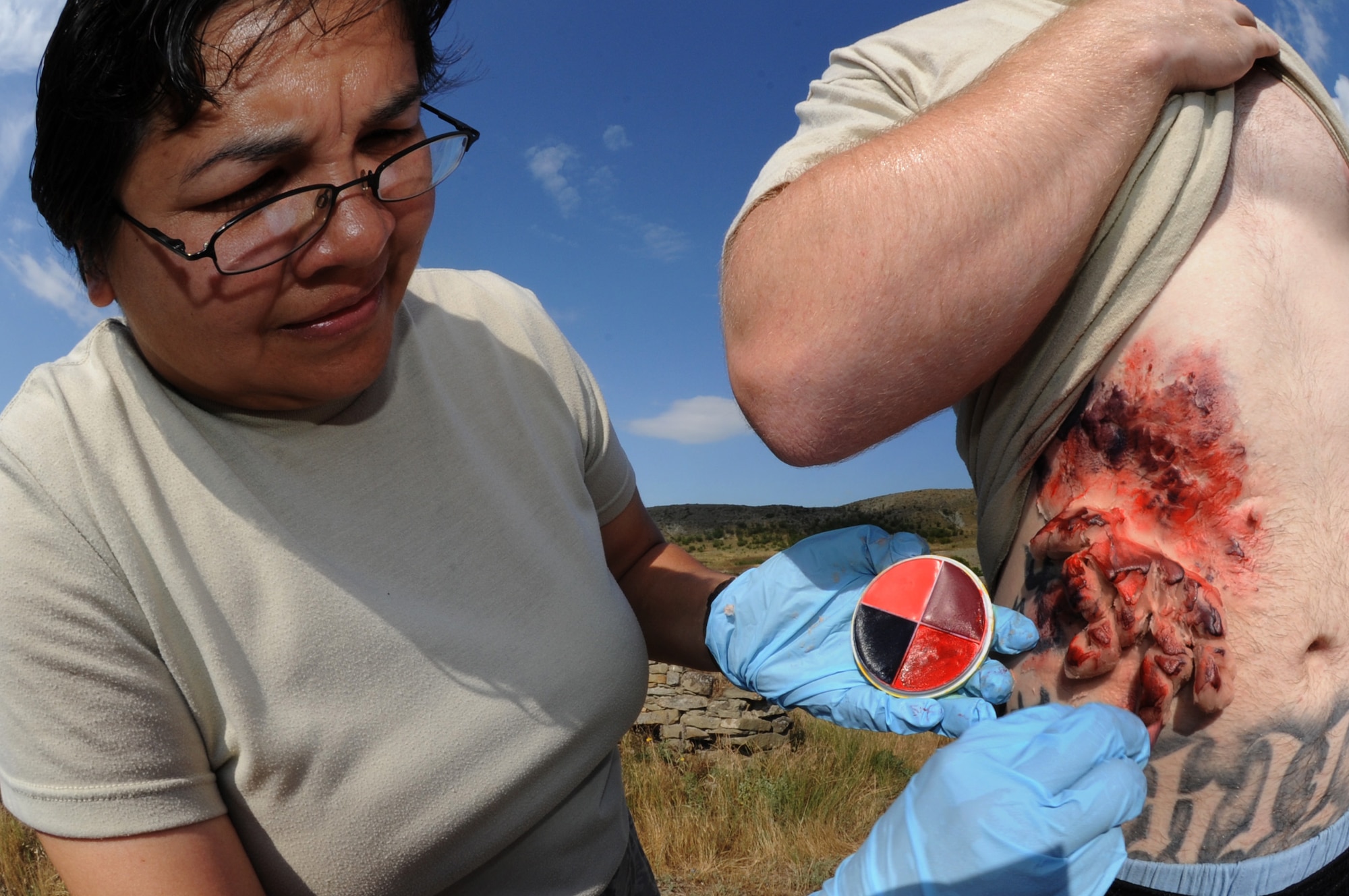KRIVOLAK, Macedonia -- Tech. Sgt. Melissa Rodriguez, 882nd Training Squadron Expeditionary Medical Support System instructor from Camp Bullis, Texas, prepares a moulage patient for a simulated mudslide scenario during the 2011 Medical Training Exercise in Central and Eastern Europe Initial Contengiency Response Team training day June 10. The annual Chairman of the Joint Chiefs of Staff-sponsored regional and multilateral exercise, MEDCEUR is designed to provide medical training and operational experience in a deployed environment for U.S. and partner nations. The countries participating in this year's MEDCEUR are Macedonia, Montenegro, Bosnia and Herzegovina, Serbia, Slovenia and Norway. (U.S. Air Force photo/Staff Sgt. Nadine Y. Barclay)