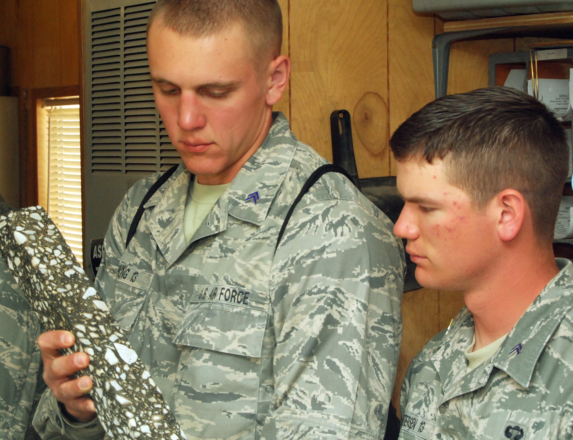 Cadets 2nd Class Anthony Vahling, left, and Ezra Petersen check out a sample of asphalt while touring the Rocky Mountain Materials and Asphalt plant in Colorado Springs, Colo., June 10, 2011. The plant tour is part of the Air Force Academy's Field Engineering Readiness Laboratory, a three-week summer course required for cadets majoring in civil or bioenvironmental engineering. Cadet Vahling, a native of Teutopolis, Ill., is assigned to Cadet Squadron 17. Cadet Petersen, a native of Wichita, Kan., is assigned to Cadet Squadron 10. (U.S. Air Force photo/Don Branum)