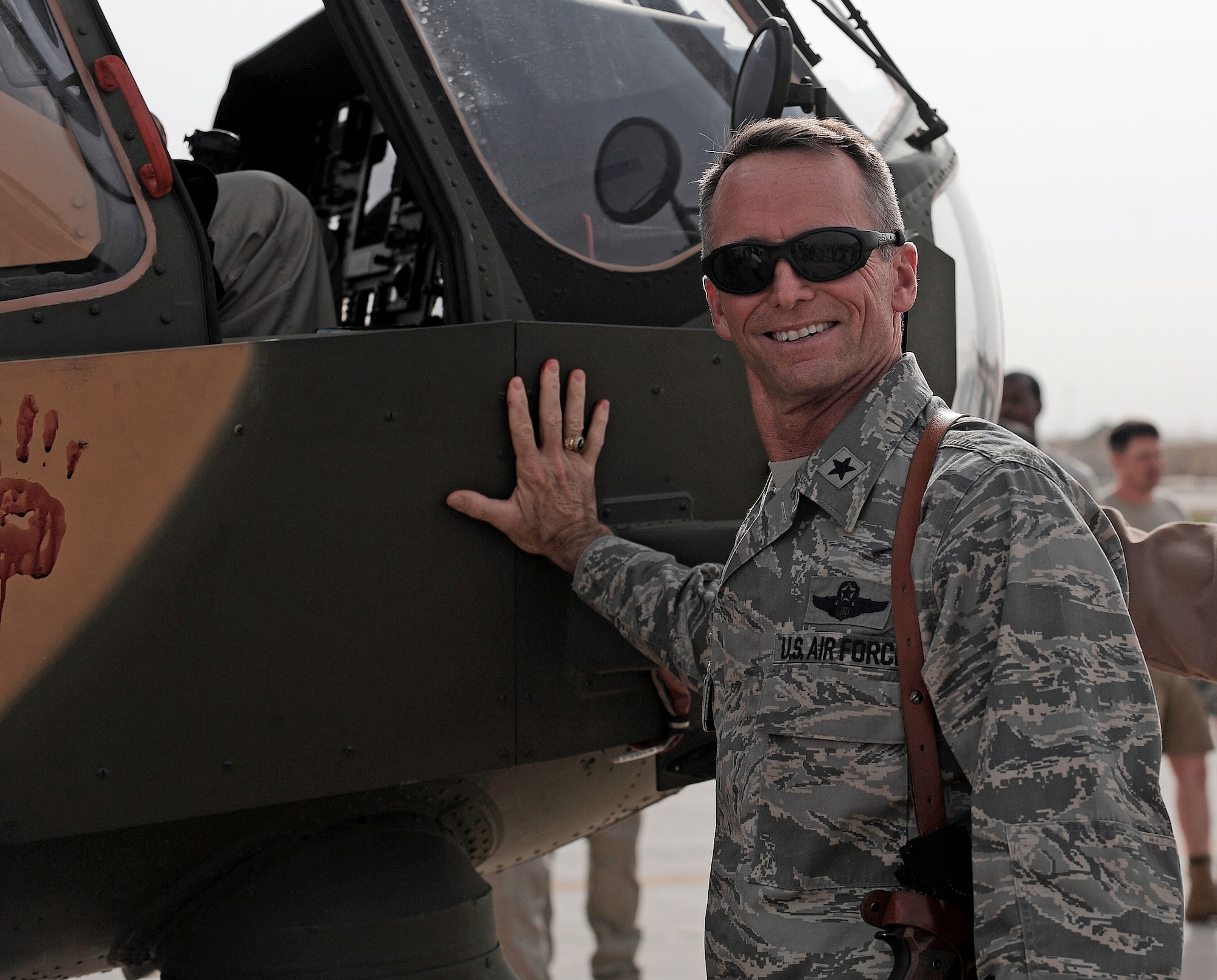 CAMP TAJI, Iraq -- Brig. Gen. Anthony Rock, Iraq Training and Advisory Mission - Air director, participates in an Mi-171E helicopter blessing ceremony with Iraqi Army Aviation Command officials June 8. More than a dozen ITAM-Air and Iraq Security Assistance Mission advisors attended a ceremony celebrating the arrival of two helicopters purchased by the Iraqis. ITAM-Air advises, trains, equips and assists their Iraqi partners on various aircraft and mission support roles. (U.S. Air Force/Tech. Sgt. Jason Lake)