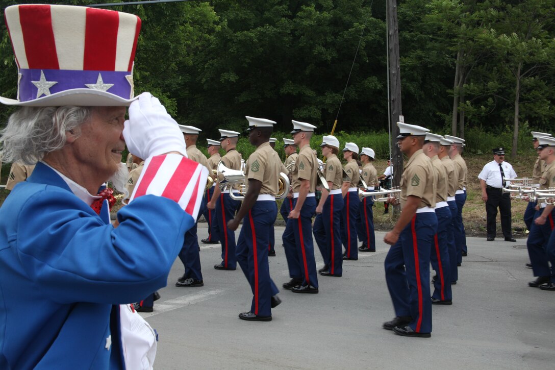 Uncle Sam salutes the 2nd Marine Aircraft Wing Band as it marches by during the 32nd Annual Troy Flag Day Parade in Troy, N.Y., June 12. According to legend, Uncle Sam was born in Troy and now the town honors the patriotic spirit with a yearly Flag Day parade. Thousands of people turn out for the parade every year.
