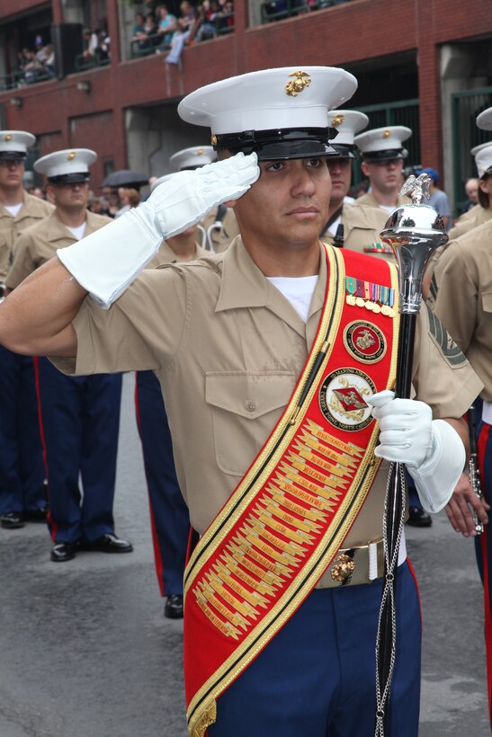 Gunnery Sgt. Victor D. Miranda, the drum major for the 2nd Marine Aircraft Wing Band, salutes during the National Anthem at the 32nd Annual Troy Flag Day Parade in Troy, N.Y., June 12. “The American flag means to me, literally everything,” said Cpl. David P. Shearin, a percussionist in the band.